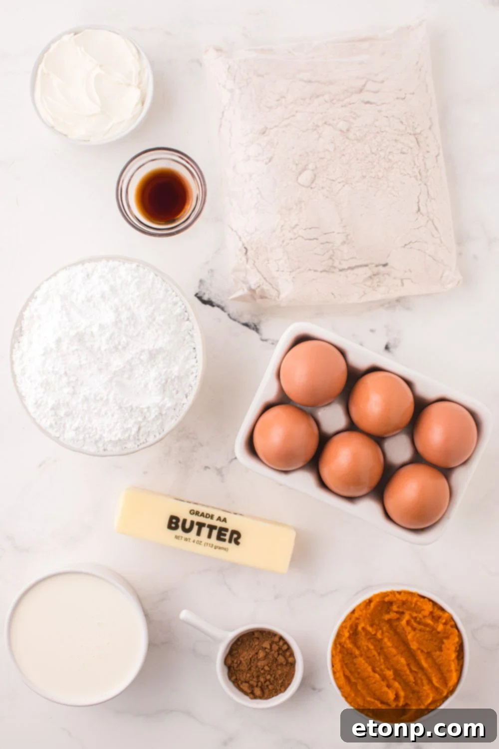 all the ingredients for Pumpkin Bundt Cake on a white table 