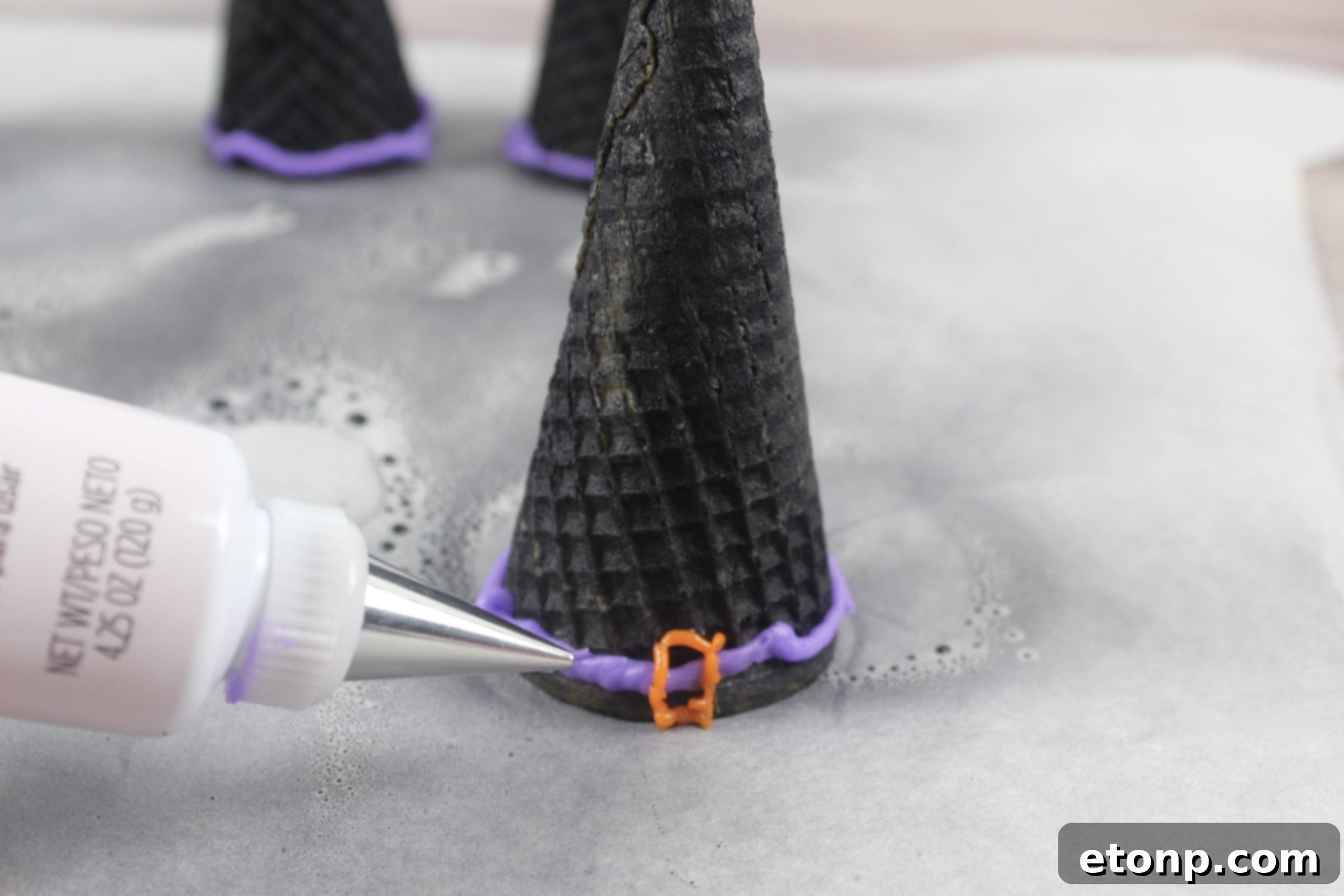 Sugar cones transformed into dark witch hats with edible black spray