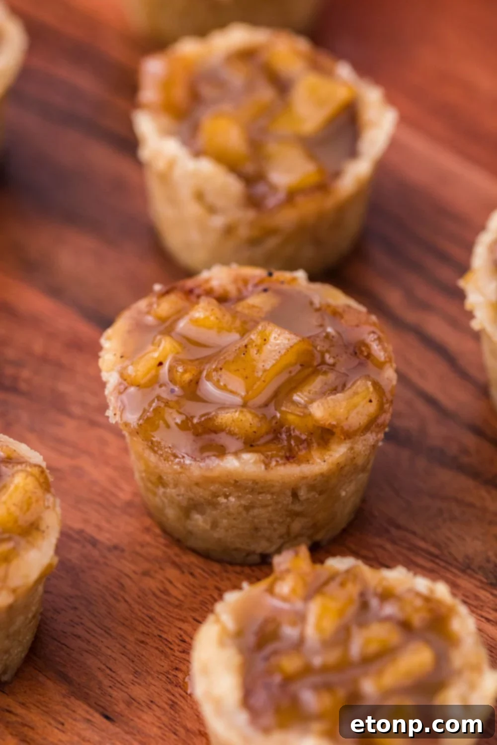 Mini Apple Crisp Bites spread out on a wooden table 