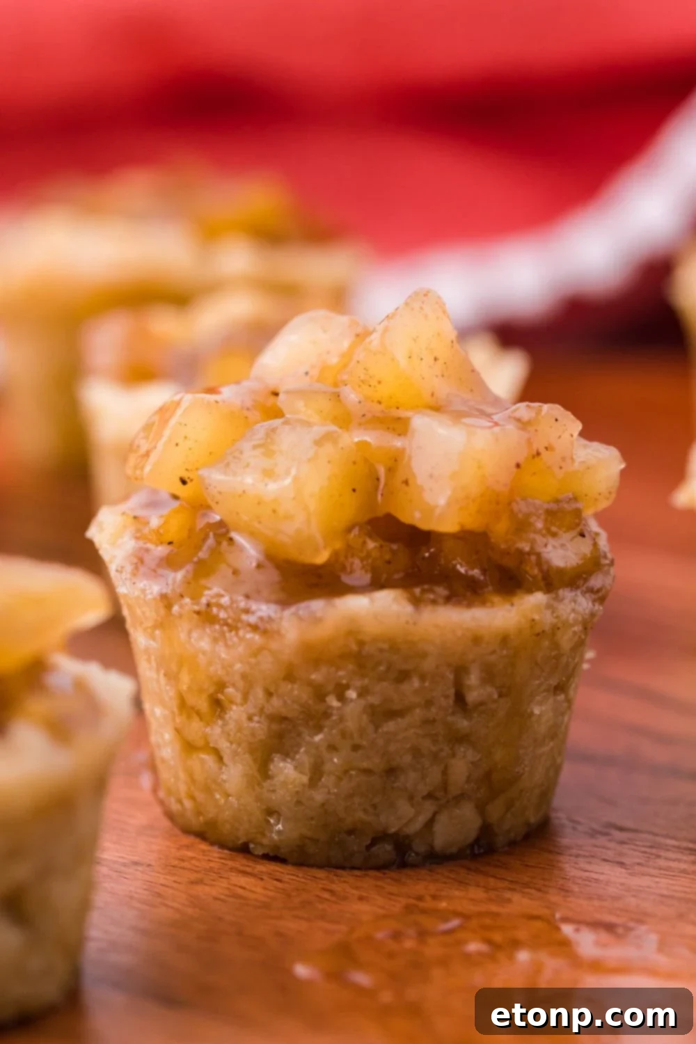 side view of a apple dessert cup with a red towel behind the background