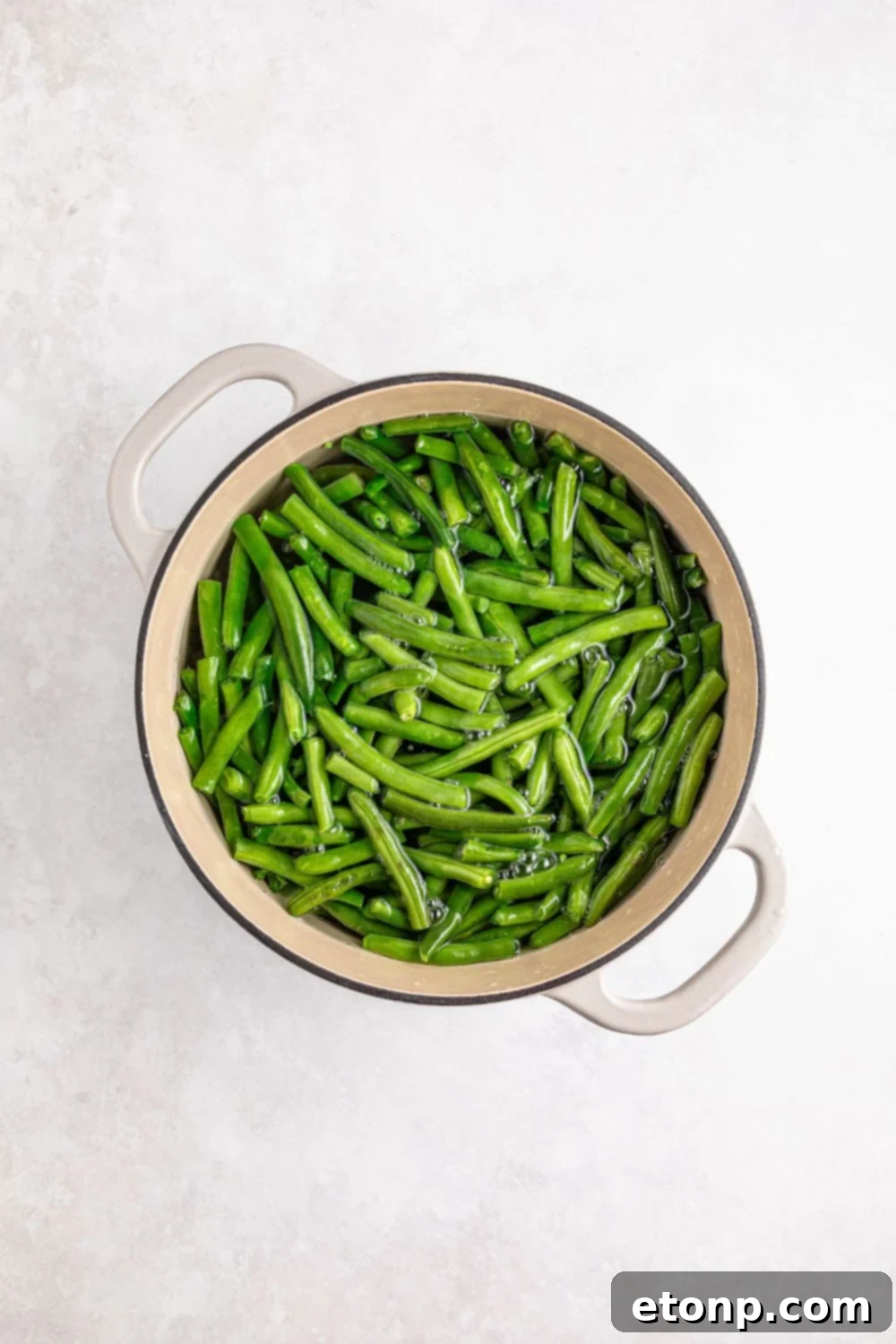 fresh green beans in a pot sitting on a table