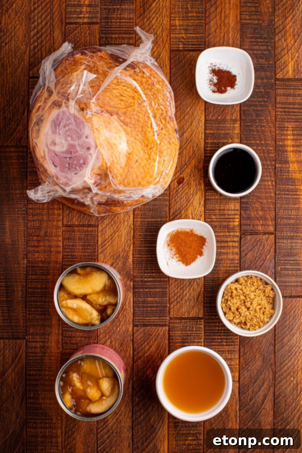 all the ingredients for apple glazed crockpot ham on a wooden table