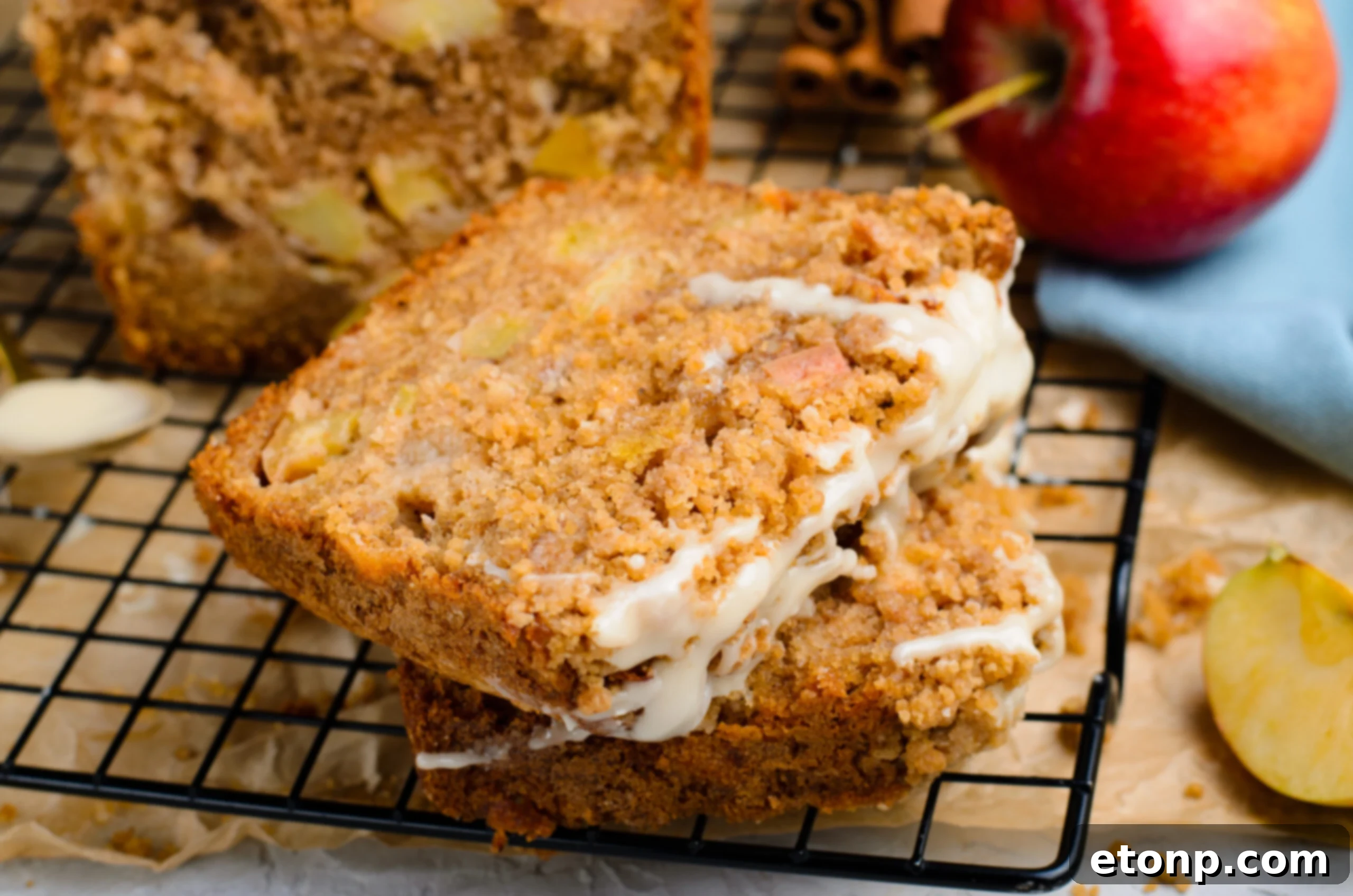 close up view of 2 slices of the Apple Cinnamon Loaf Cake on a cooling rack