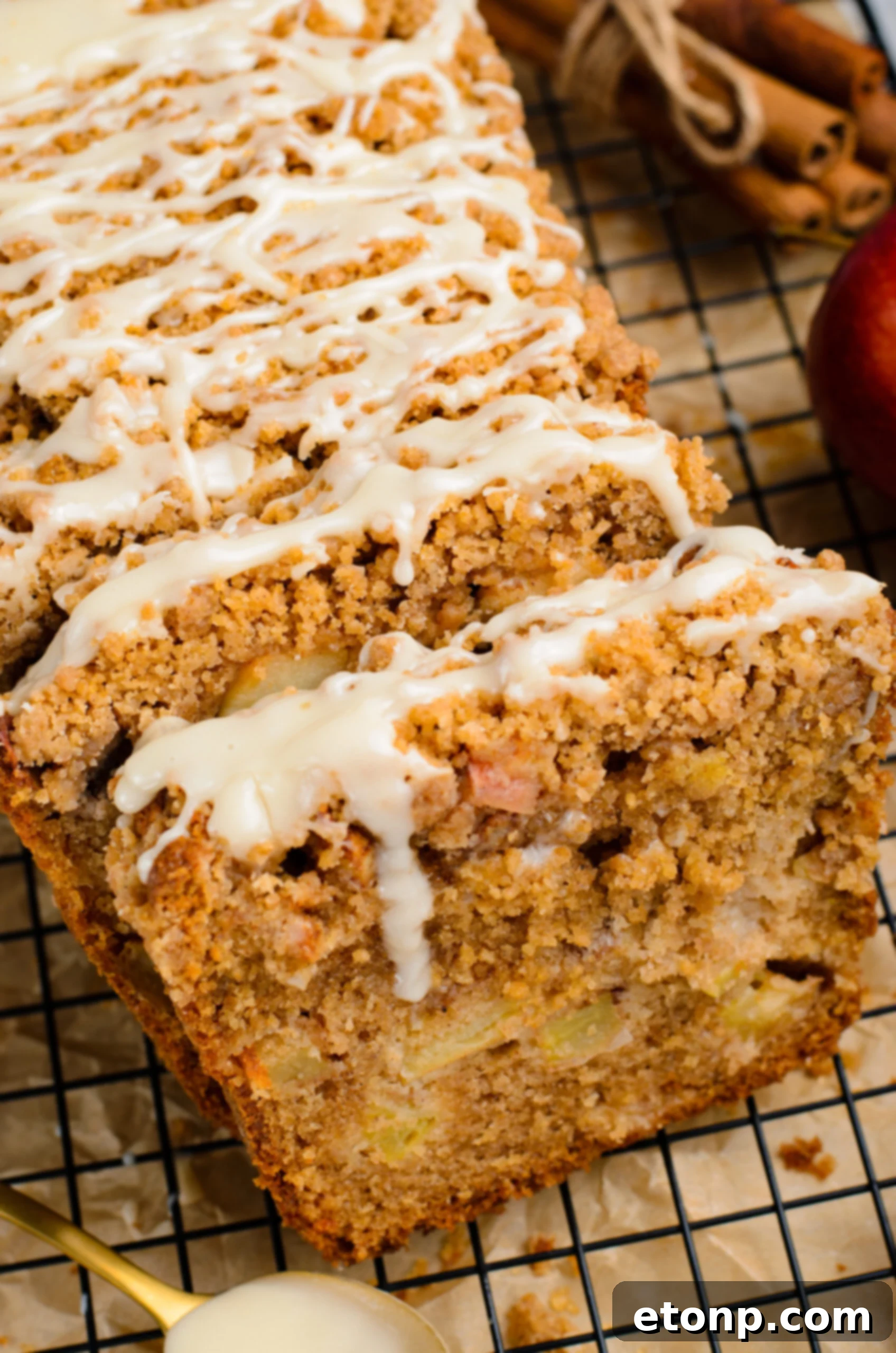 close up view of the entire loaf of the Apple Cinnamon Loaf Cake on a black cooling rack