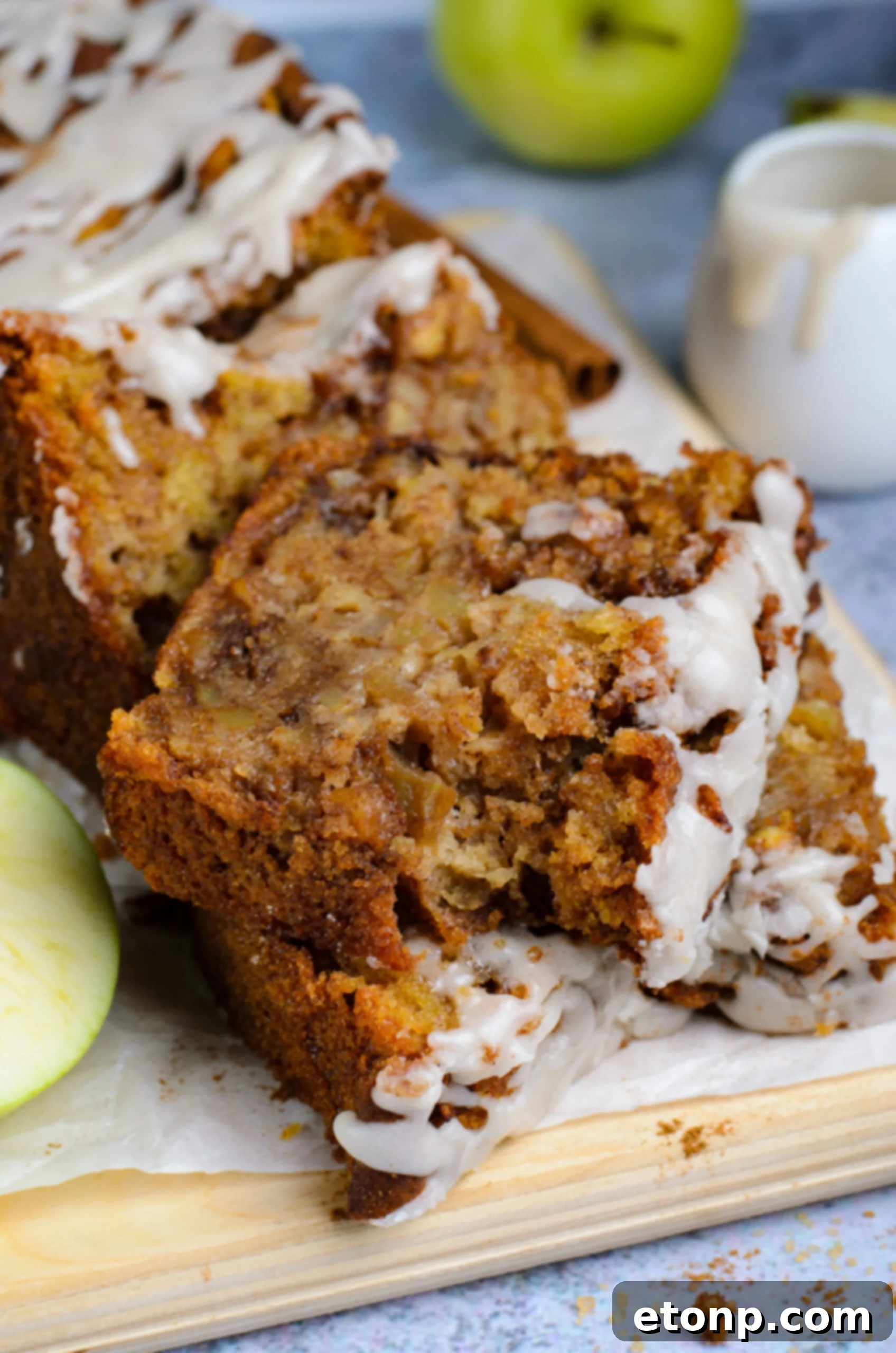 two slices of Amish Apple Fritter Bread on a wooden cutting board