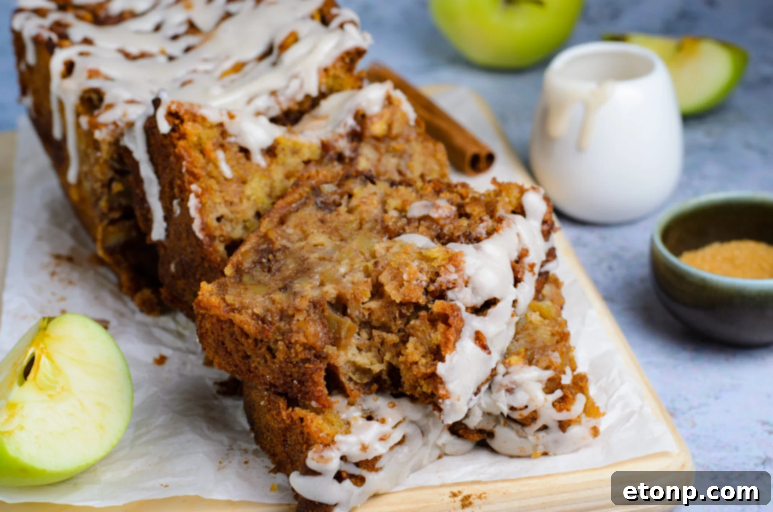 two slices of Amish Apple Fritter Bread on a wooden cutting board
