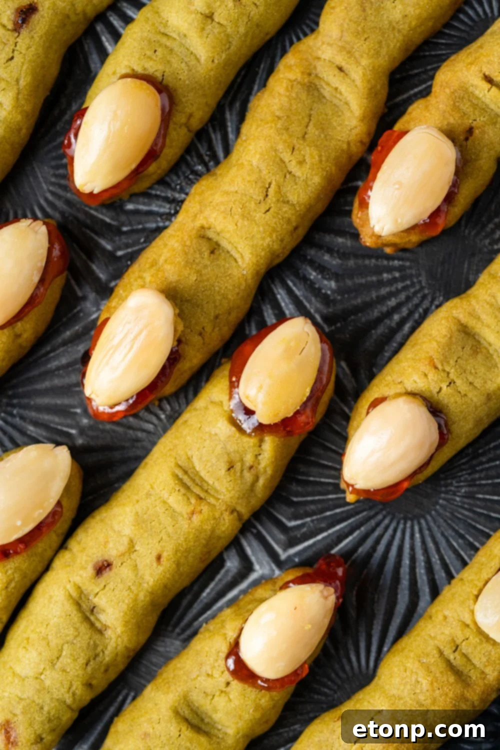 Witch Finger Cookies placed neatly on a black tray on table to see the detail of each cookie 