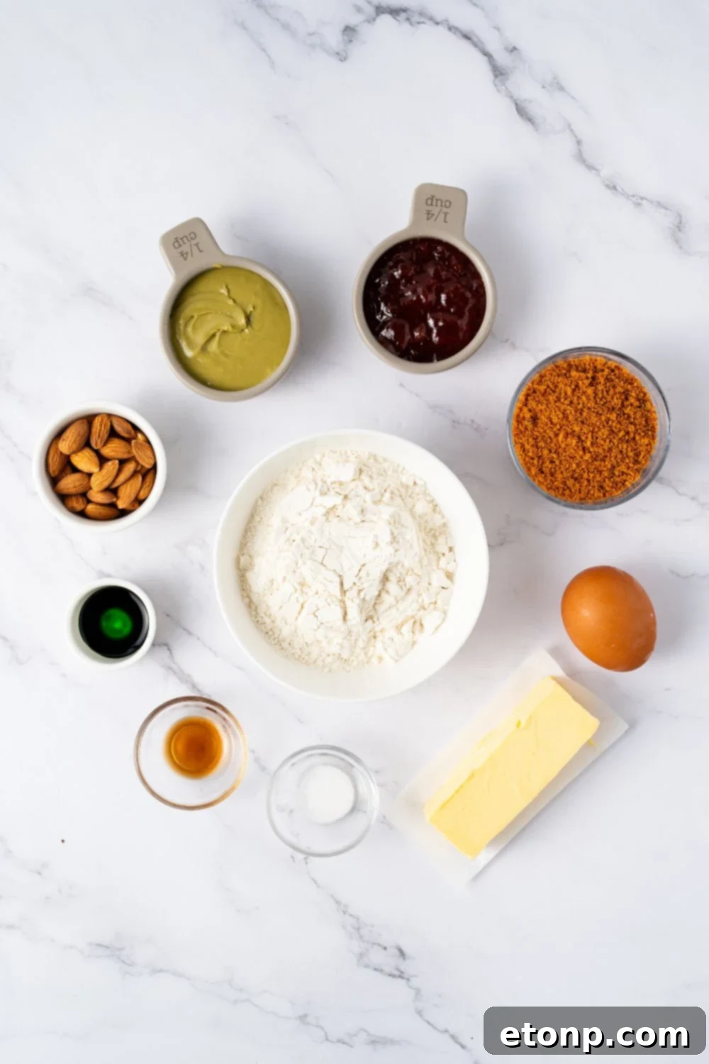 ingredietns for Witch Finger Cookies in single serve containers on a marble counter 
