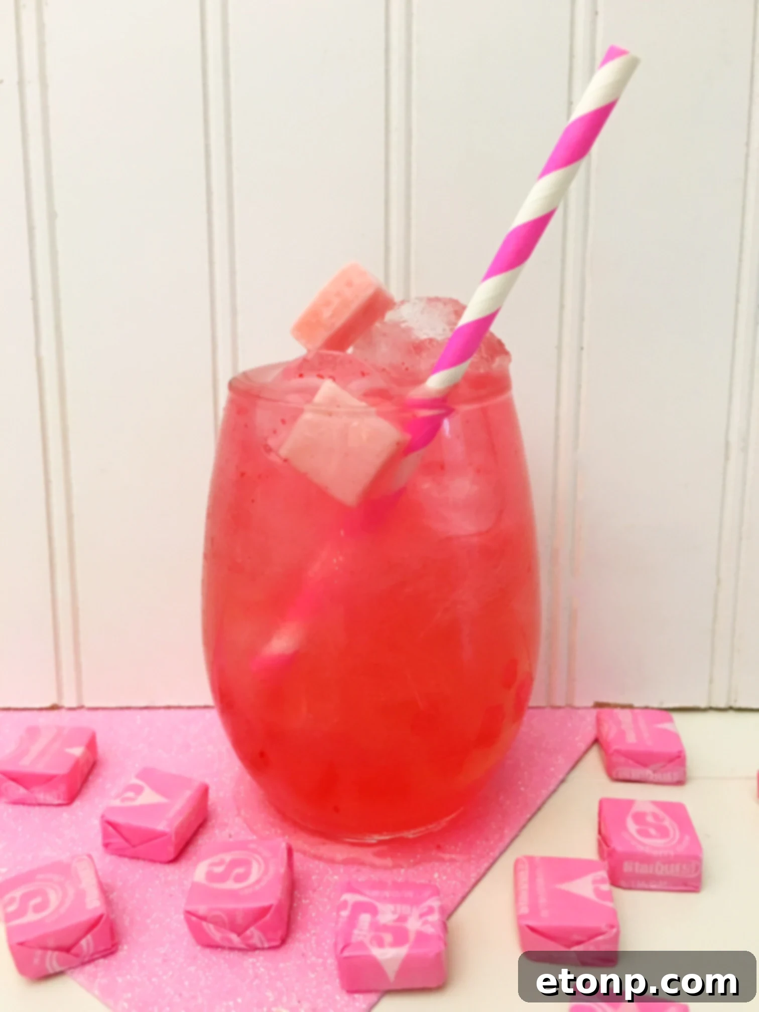 Blush Berry Bliss 4 Overhead shot of a single Pink Starburst cocktail with Starburst candies and ice, highlighting its vibrant color.