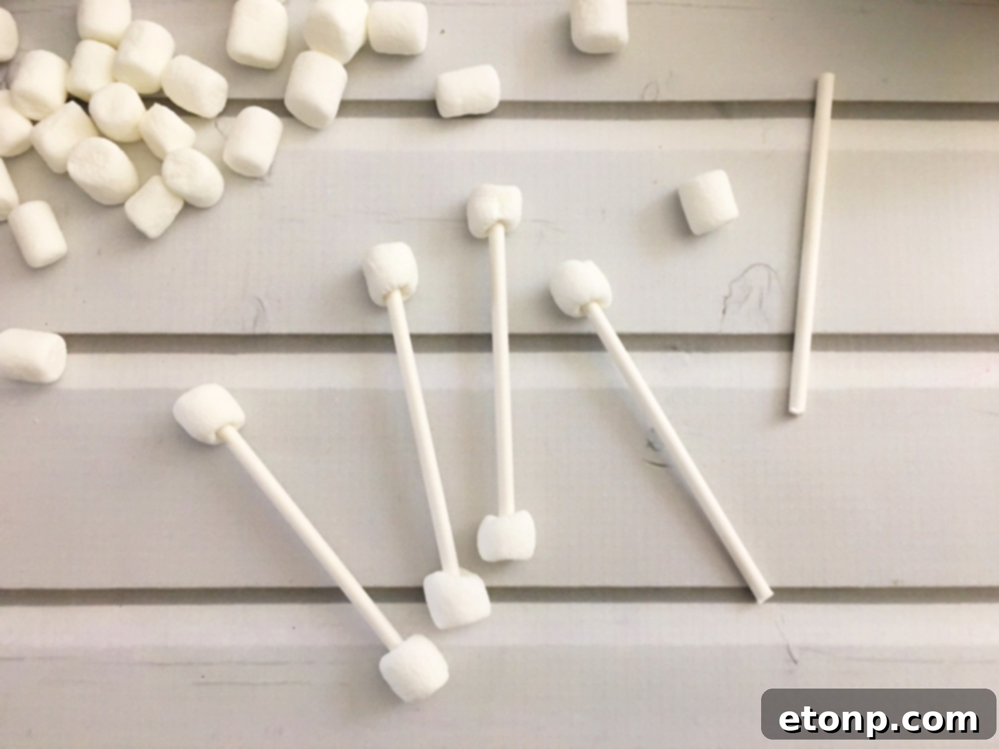 Several 'dirty Q-tip' Halloween treats arranged on a plate, ready for a spooky party.