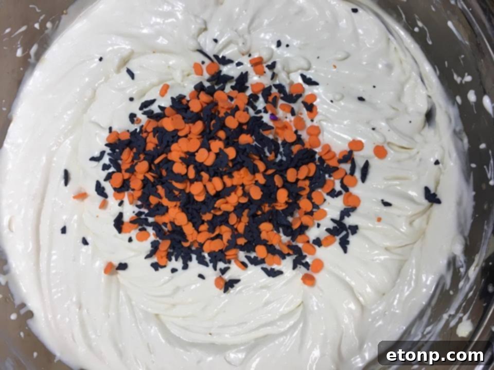 Close-up of Halloween Cheesecake with vibrant sprinkles visible in the cheesecake layer