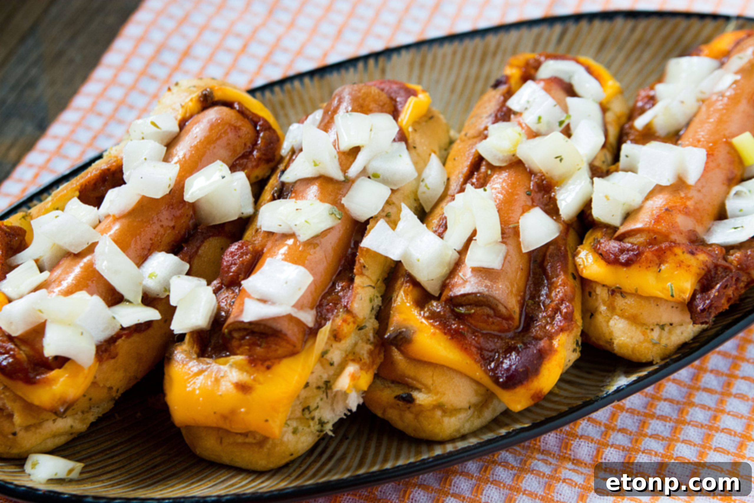 Loaded Chili Cheese Dog Boats 2 Delicious baked chili cheese dog boats arranged in a baking dish, ready to be served.