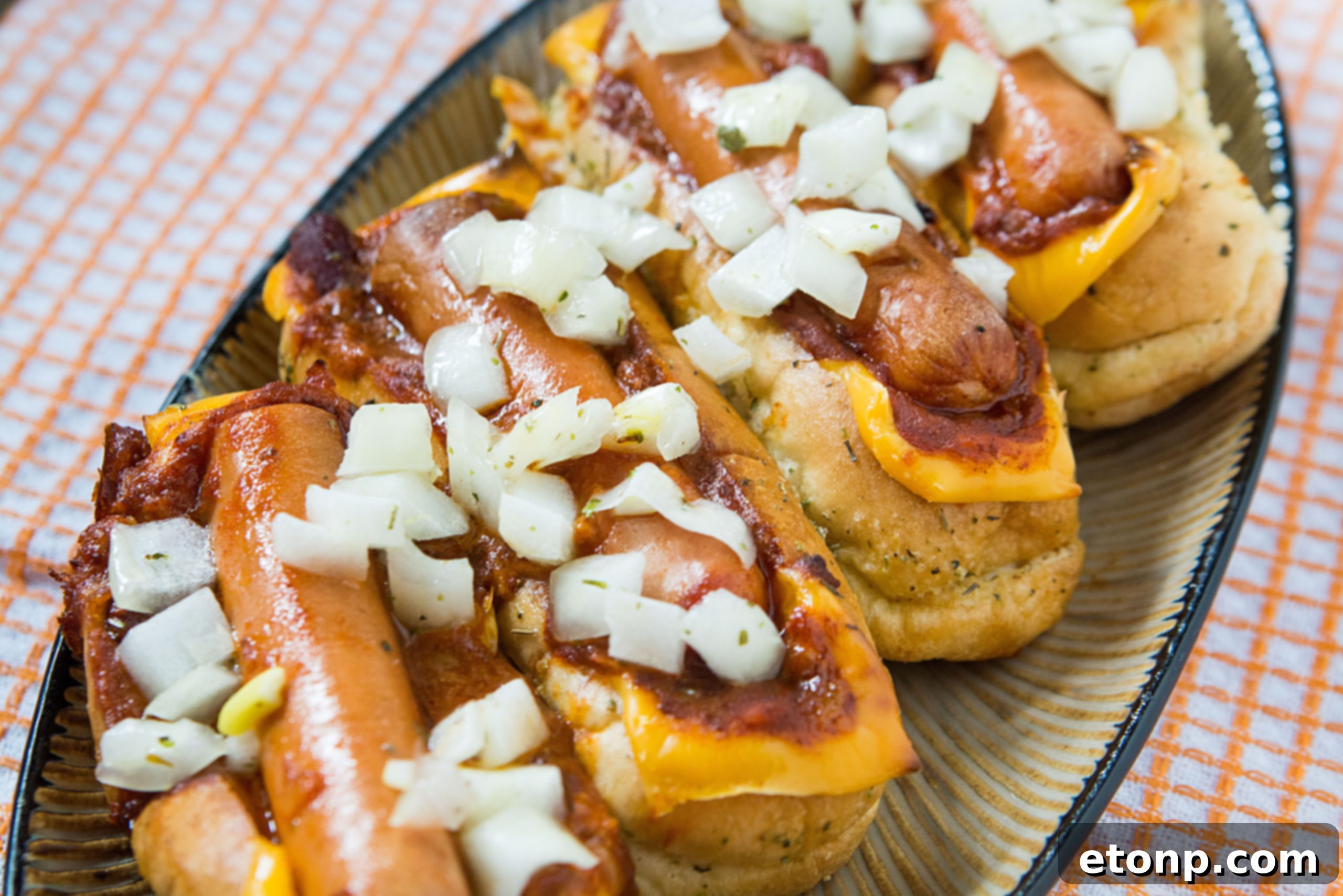 Loaded Chili Cheese Dog Boats 11 Finished chili cheese dog boats, golden brown and bubbly, fresh out of the oven.