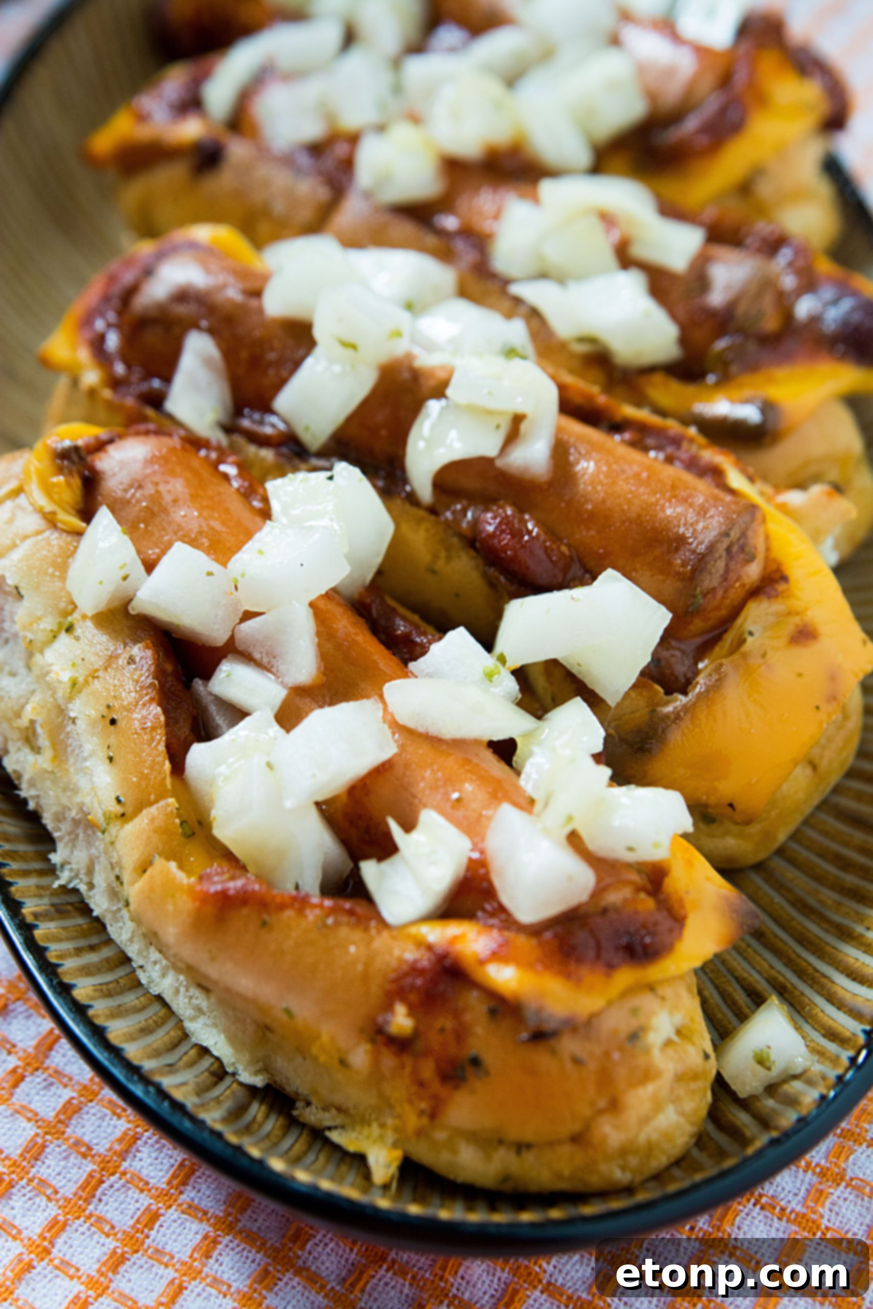 Loaded Chili Cheese Dog Boats 12 Serving suggestion for chili cheese dog boats, showing one boat ready to be enjoyed.