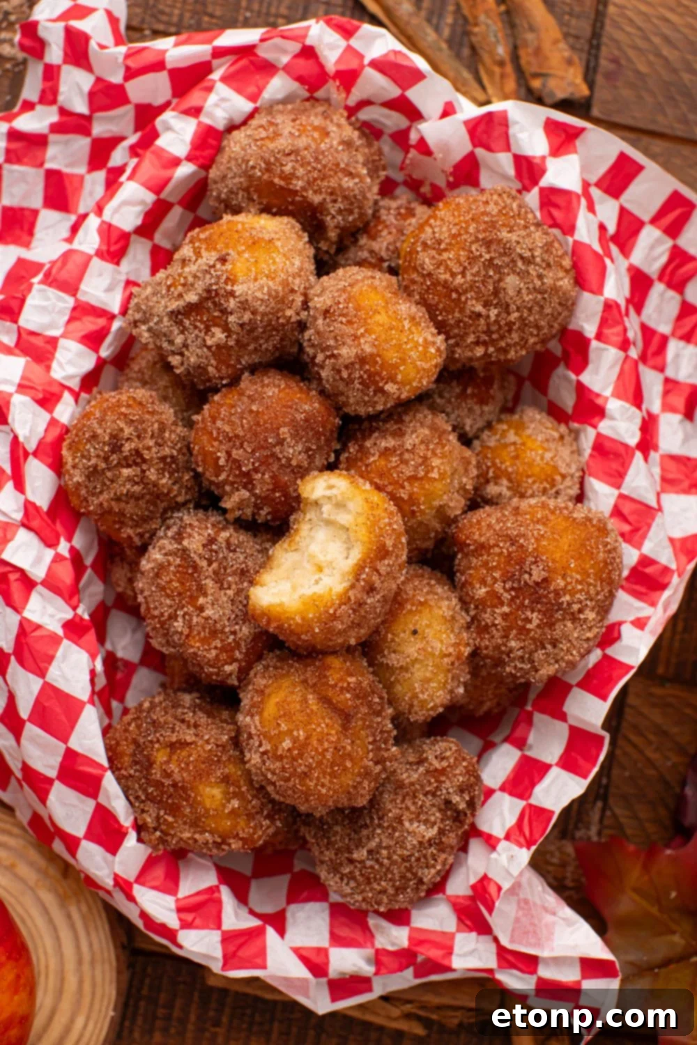 wooden table with a basket full of Apple Pie Donut Holes inside 