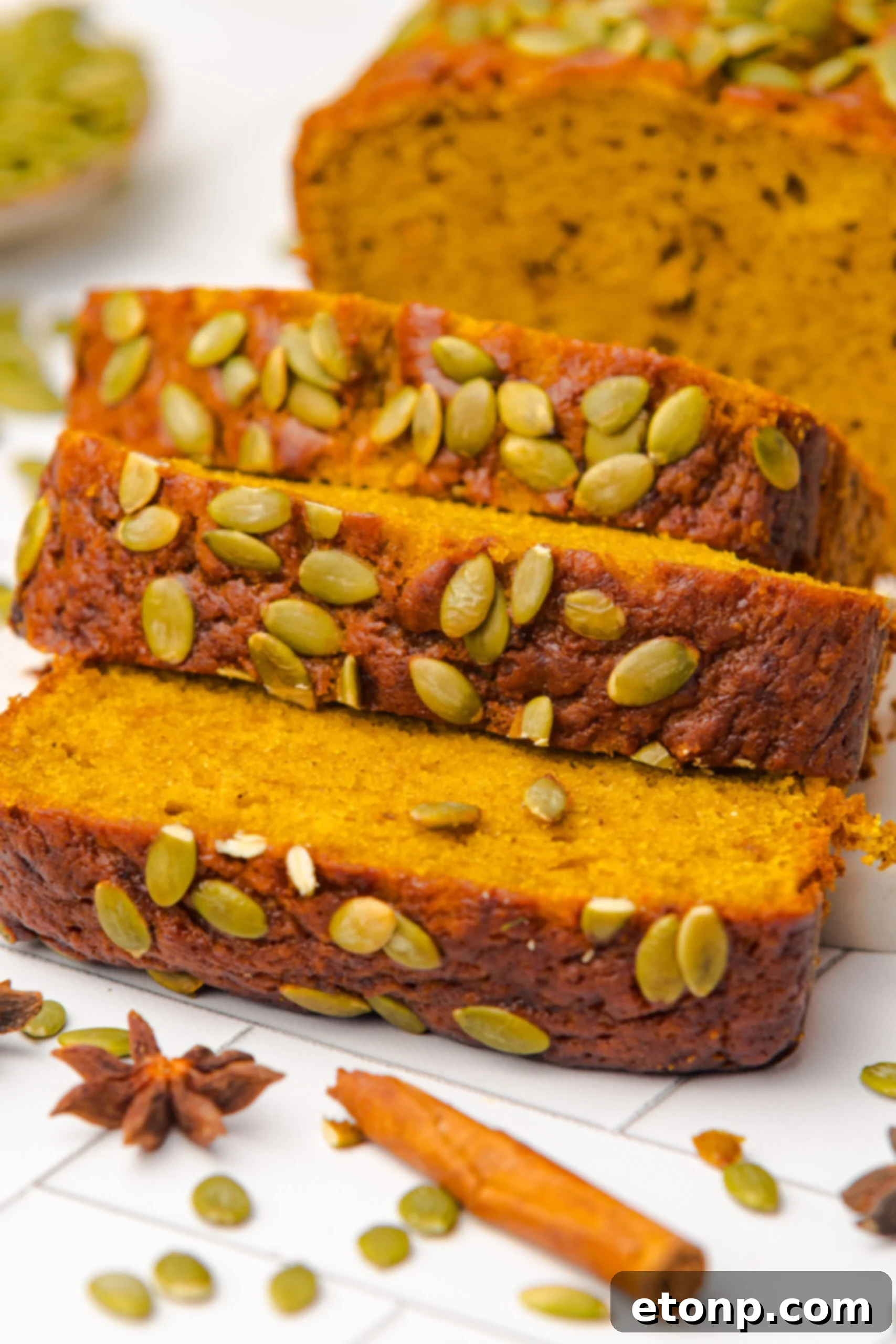 Starbucks Pumpkin Bread   sliced and placed on table with pumpkin seeds on top of each loaf 