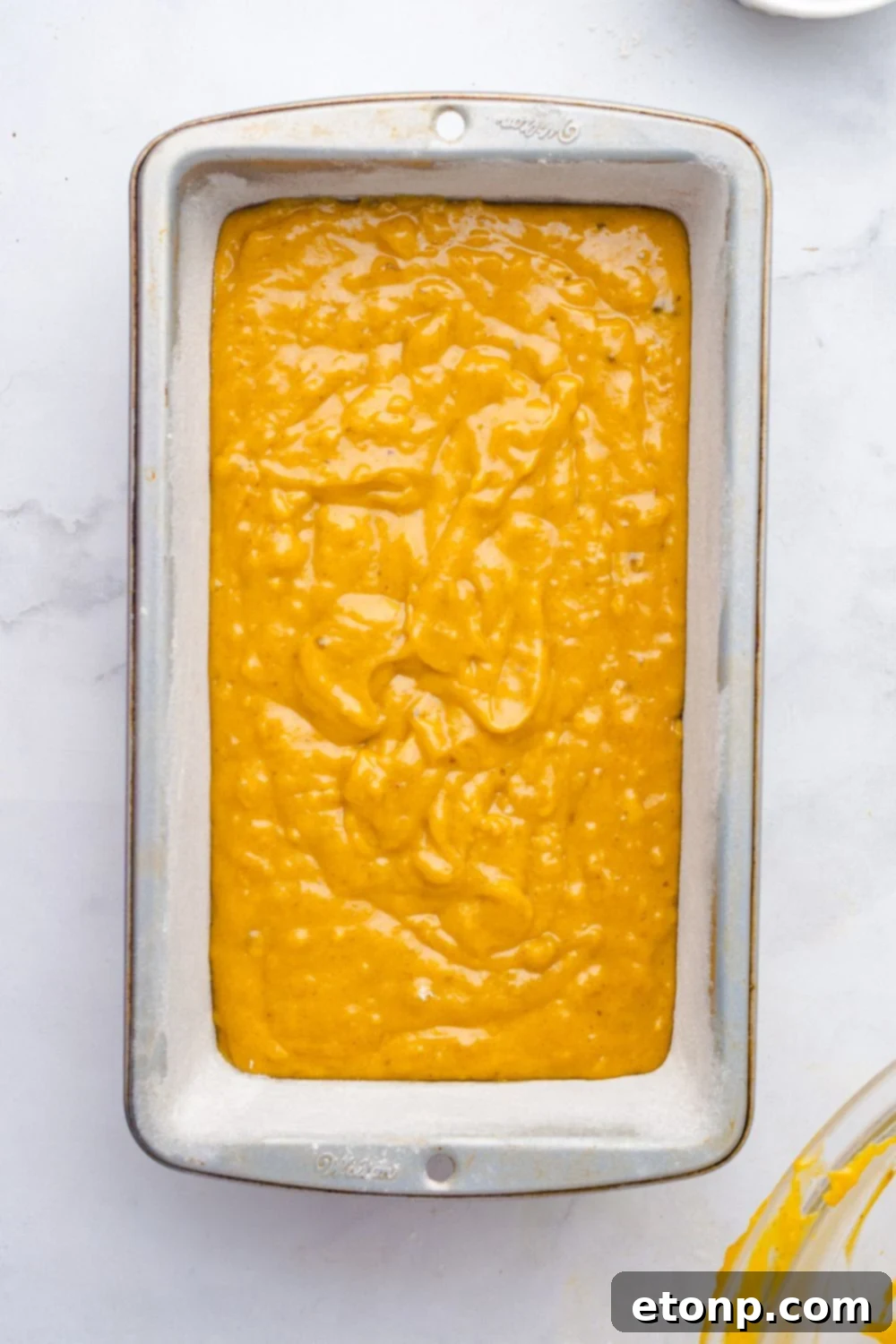 Starbucks Pumpkin Bread batter in a loaf pan on table 