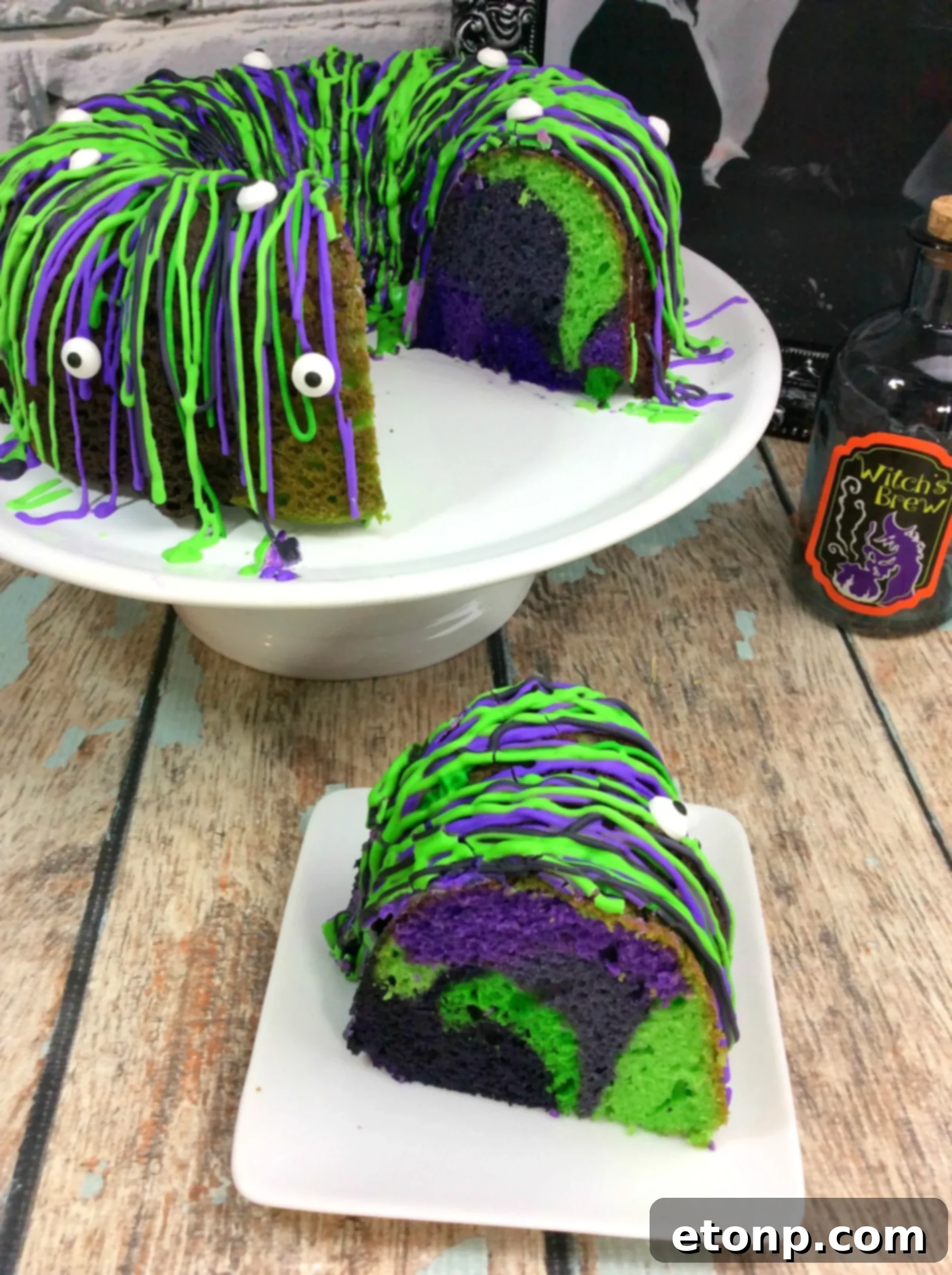 Side view of the Witches Brew Halloween Cake with purple, black, and green icing and edible eyes