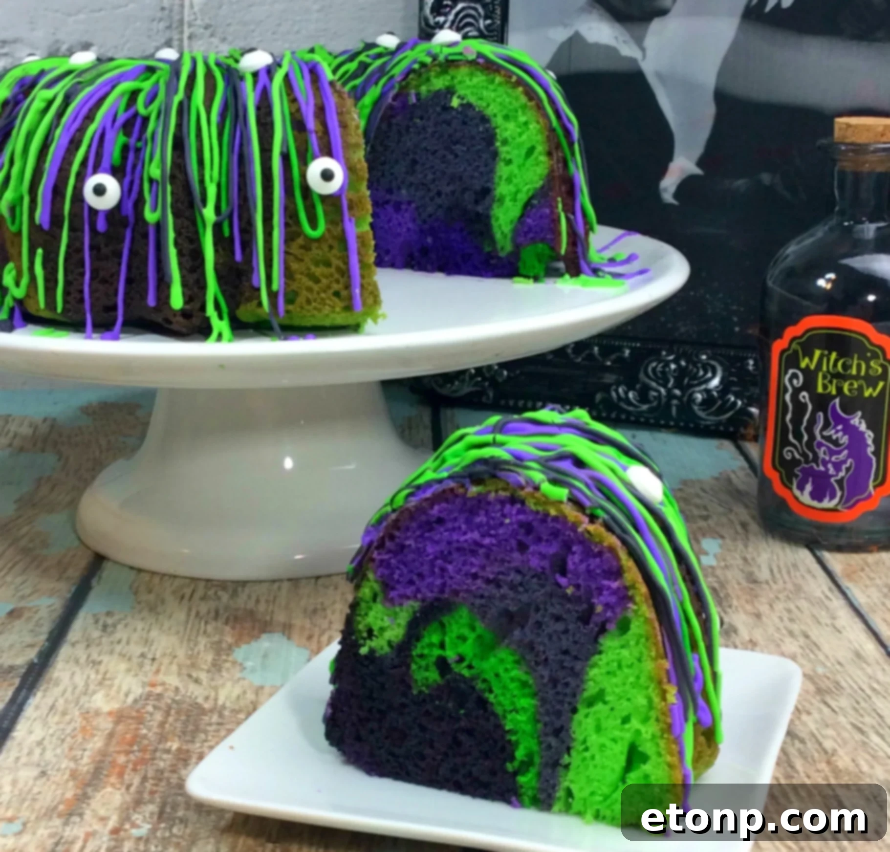 A slice of Witches Brew Halloween Cake showing the inside's colorful layers and the outer icing with eyes