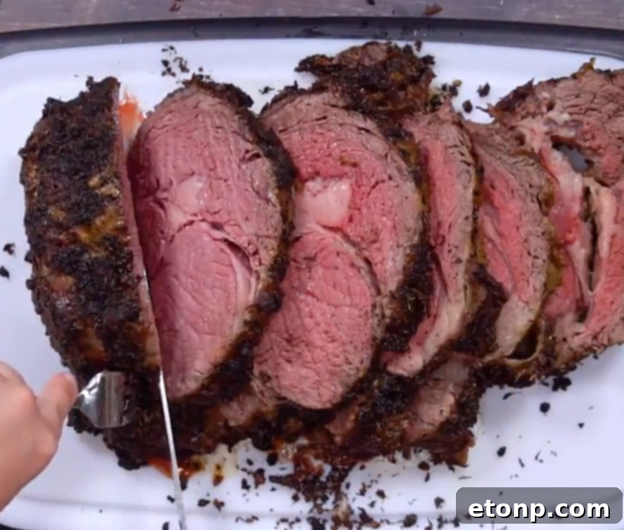 Close-up of a perfectly cooked slice of prime rib with a pink center