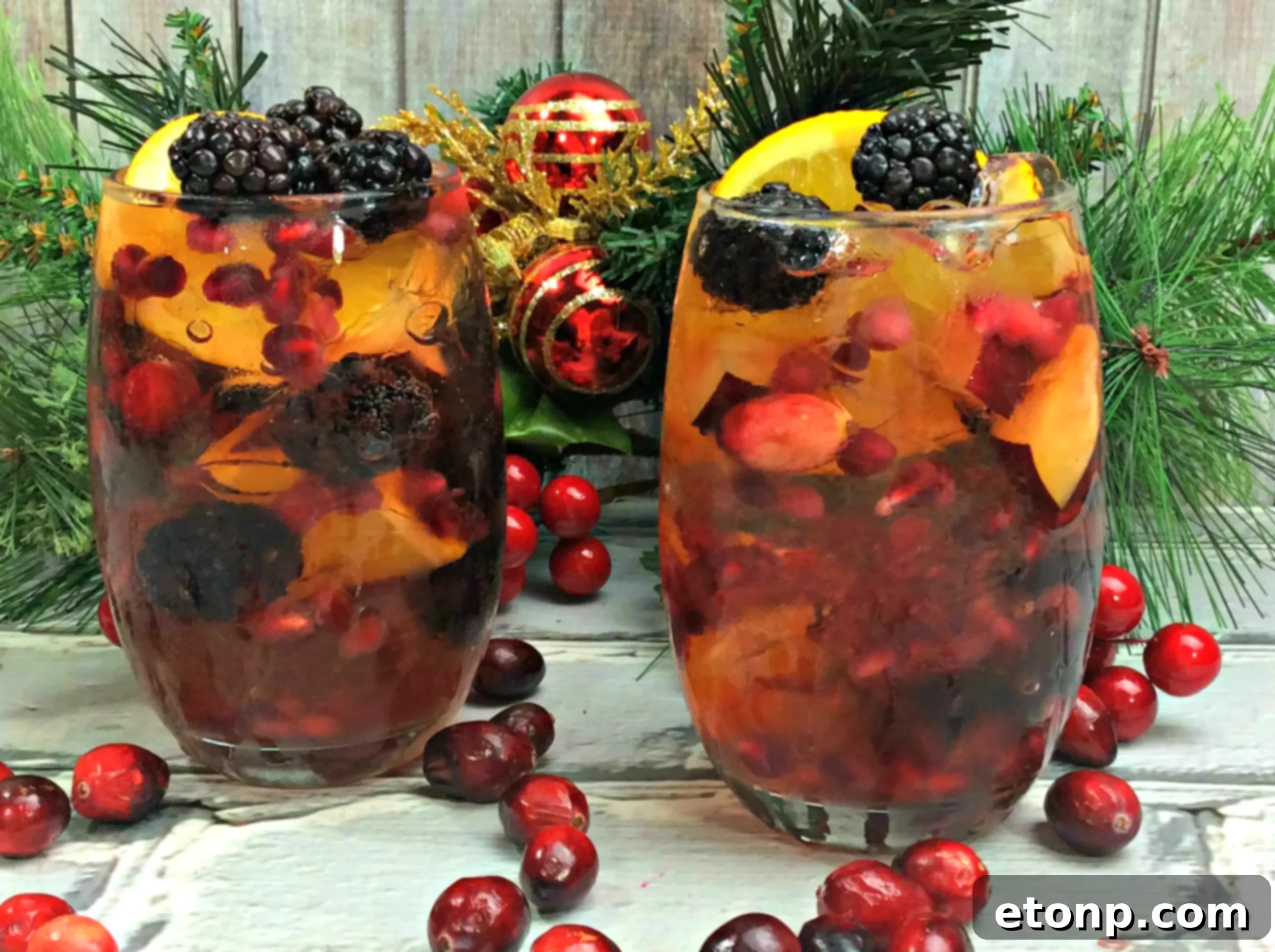 Close-up of a glass of white wine sangria, garnished with colorful fruits and ice, showcasing its refreshing appeal and beautiful presentation.