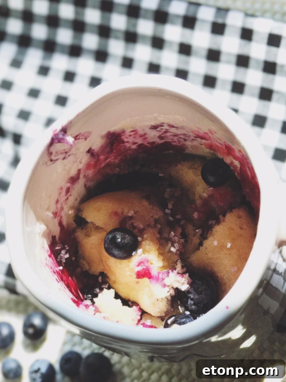 Close-up of the blueberry muffin mug cake with melted butter or syrup