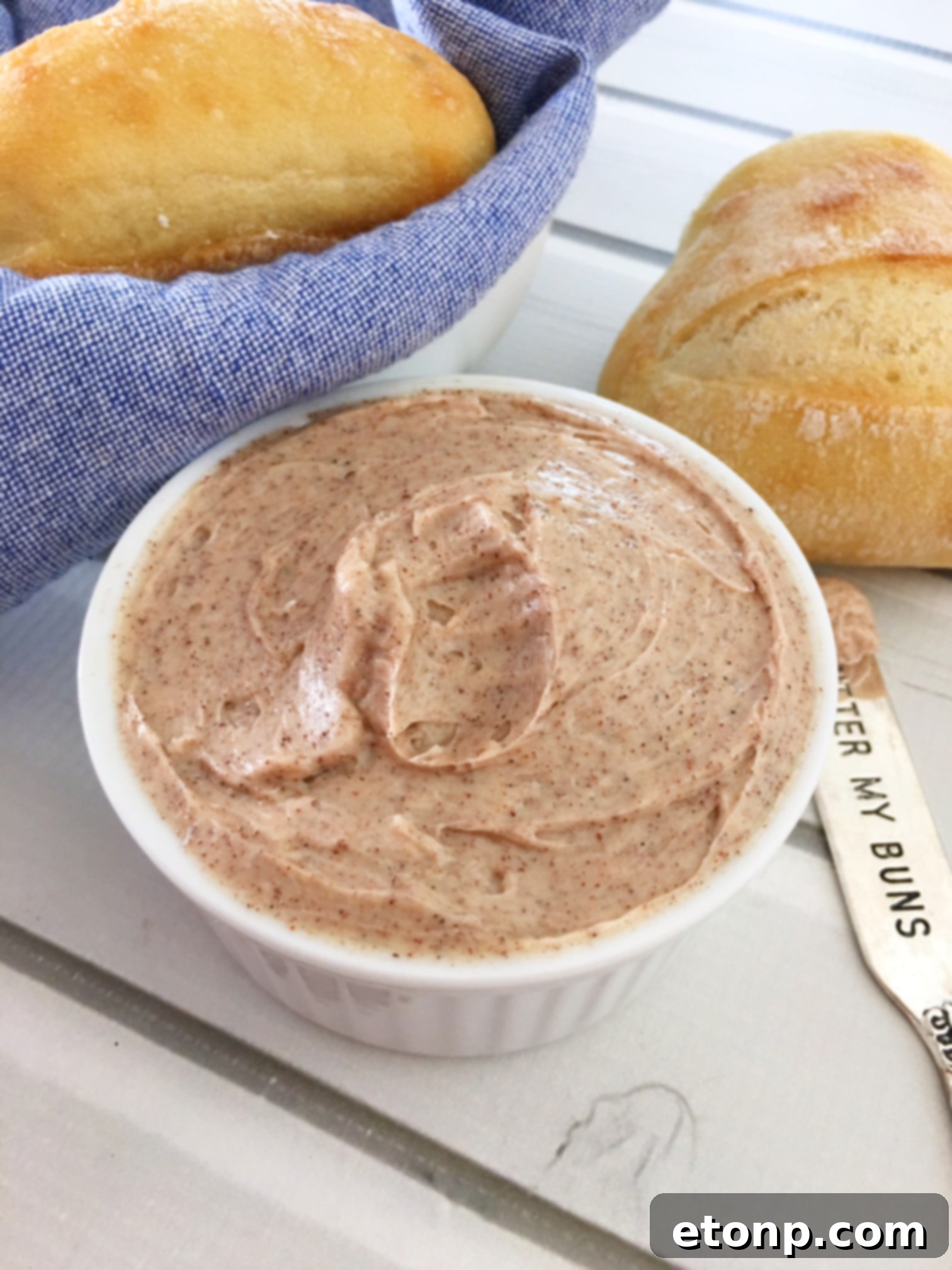 Four ingredients laid out for cinnamon honey butter: butter, honey, powdered sugar, cinnamon