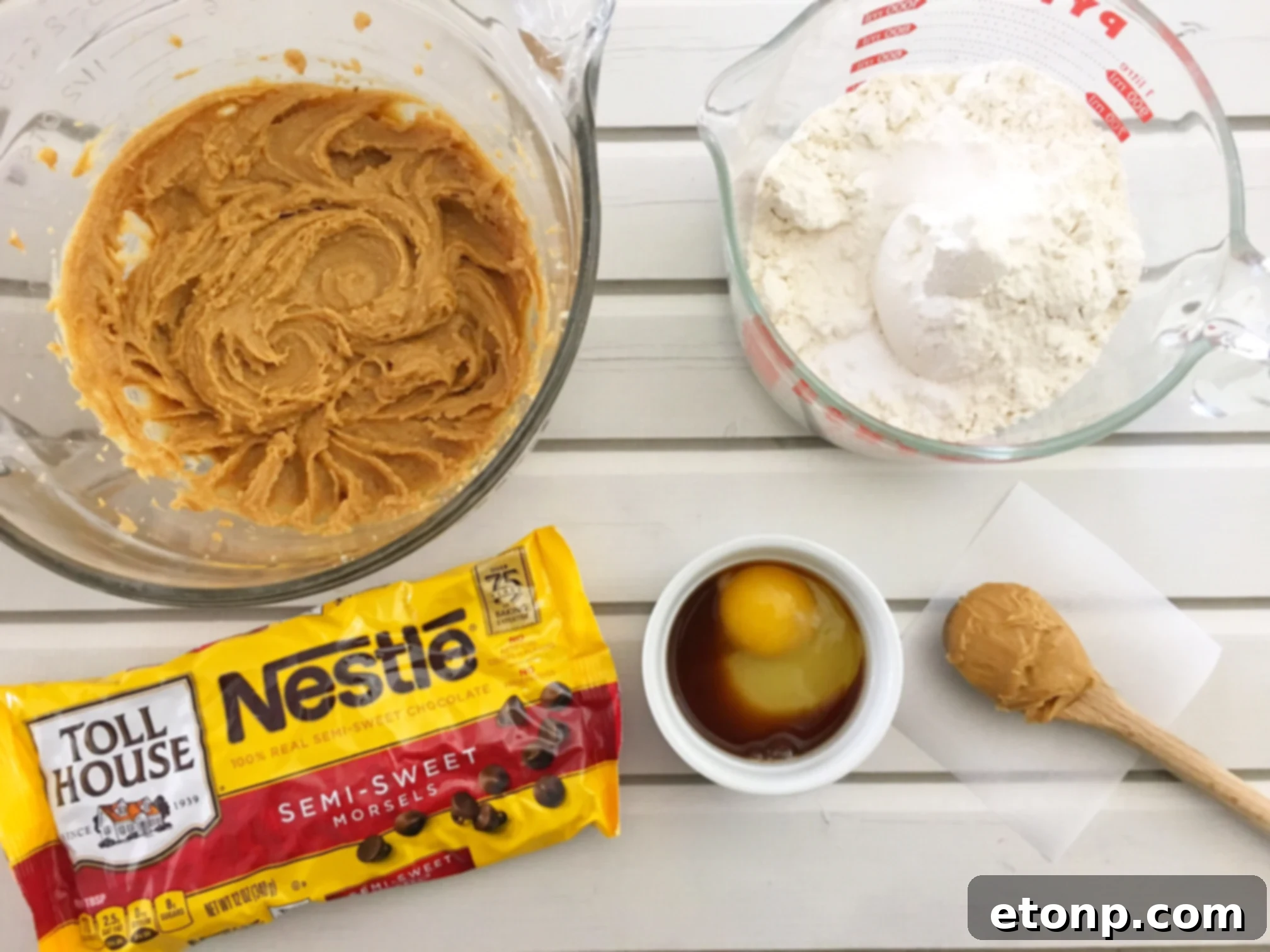 Stack of soft peanut butter cookies with a bite taken out, showing chewy texture