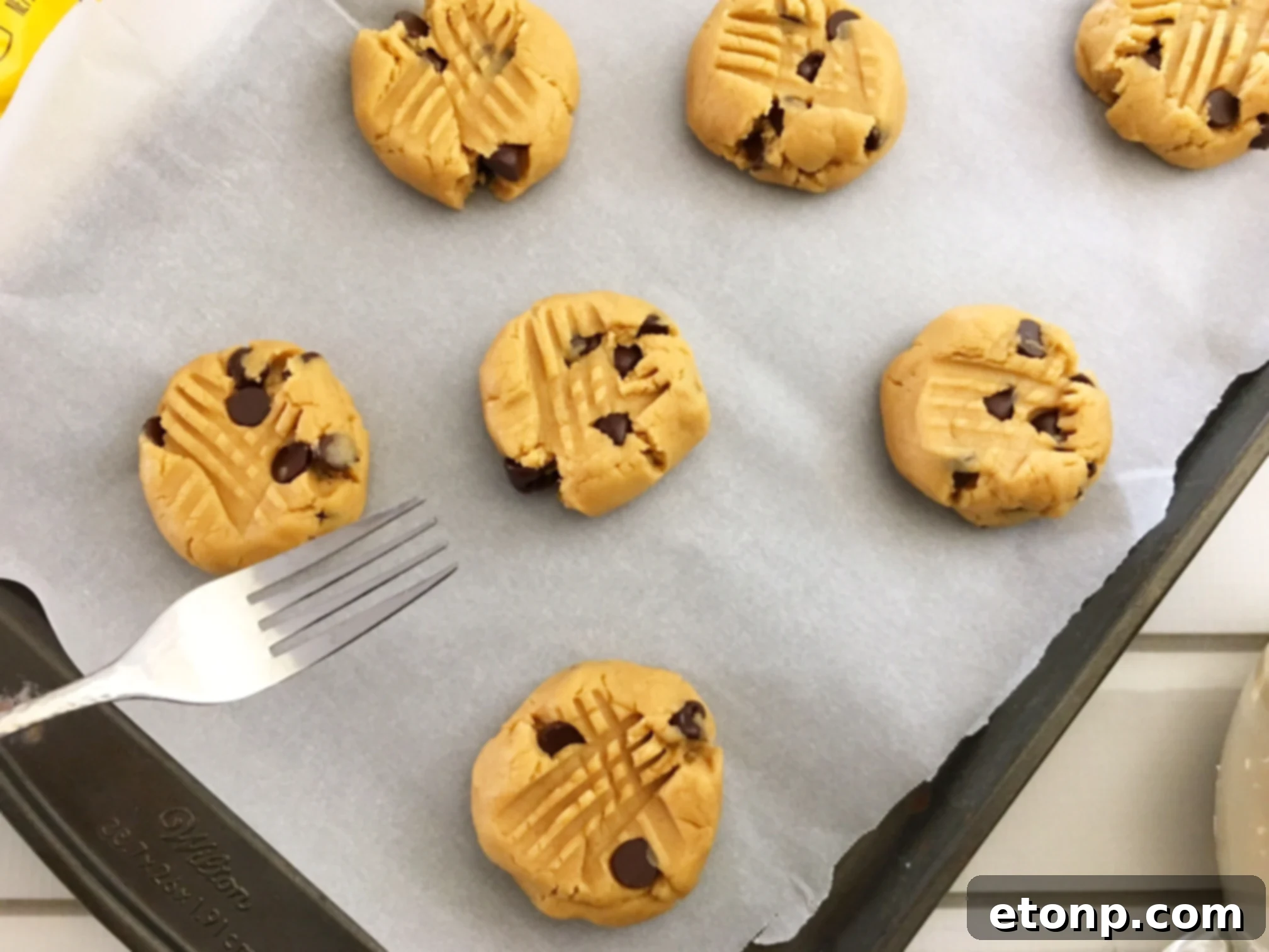 A tray of fresh peanut butter cookies cooling, ready to be enjoyed