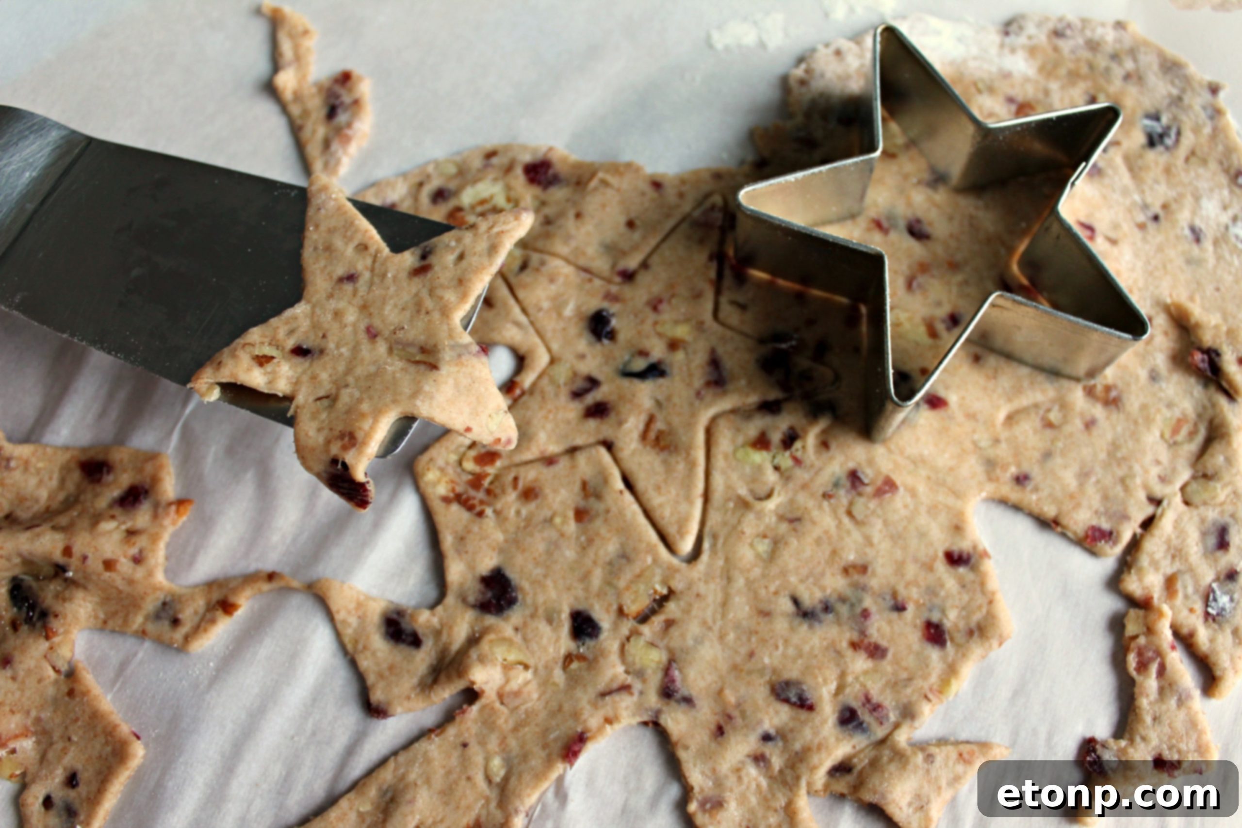 Close-up of crispy bacon, sweet cranberries, and crunchy pecans, key ingredients for the crackers