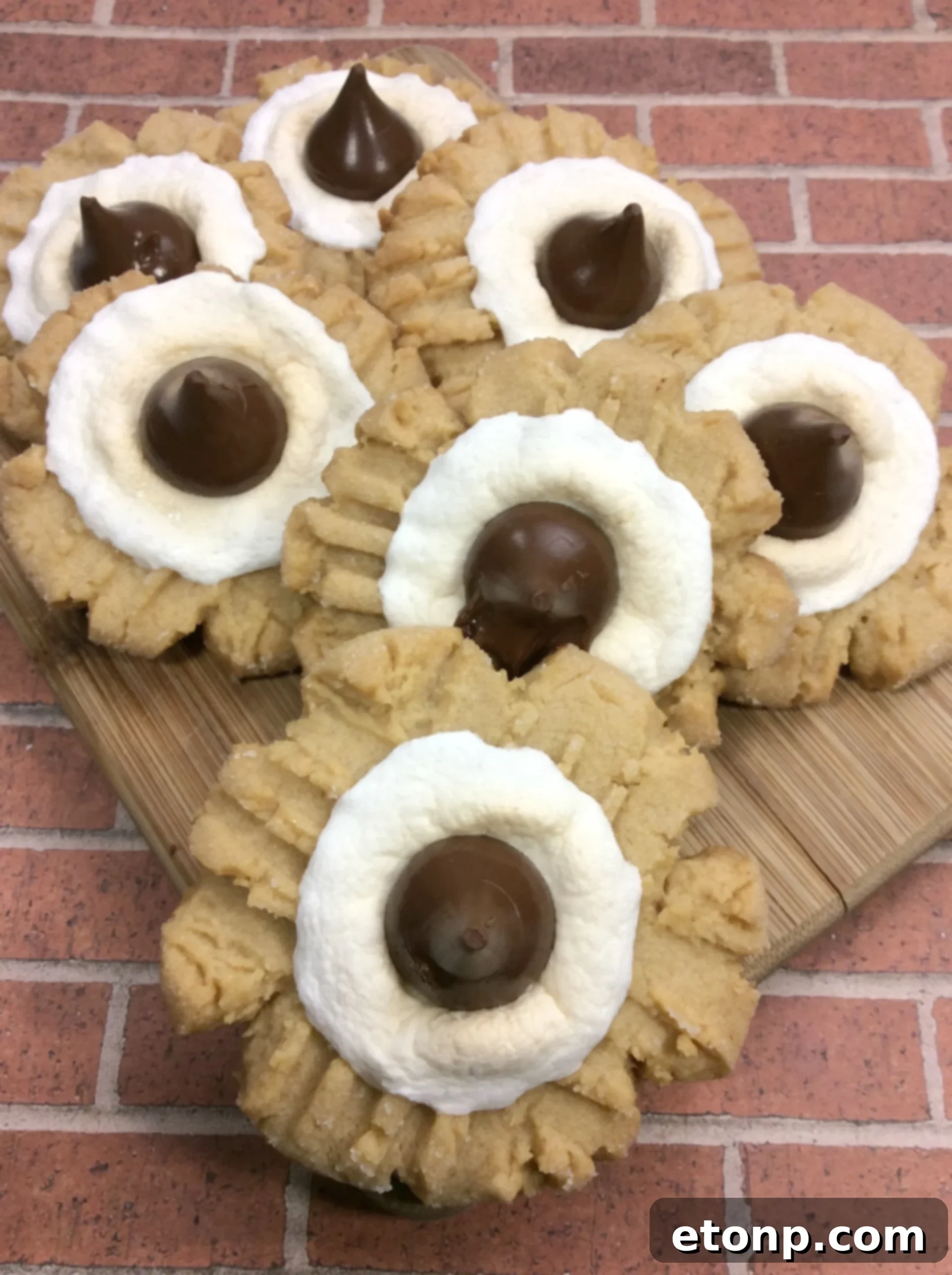 Spread of finished Peanut Butter S'mores Cookies on a baking sheet with parchment paper