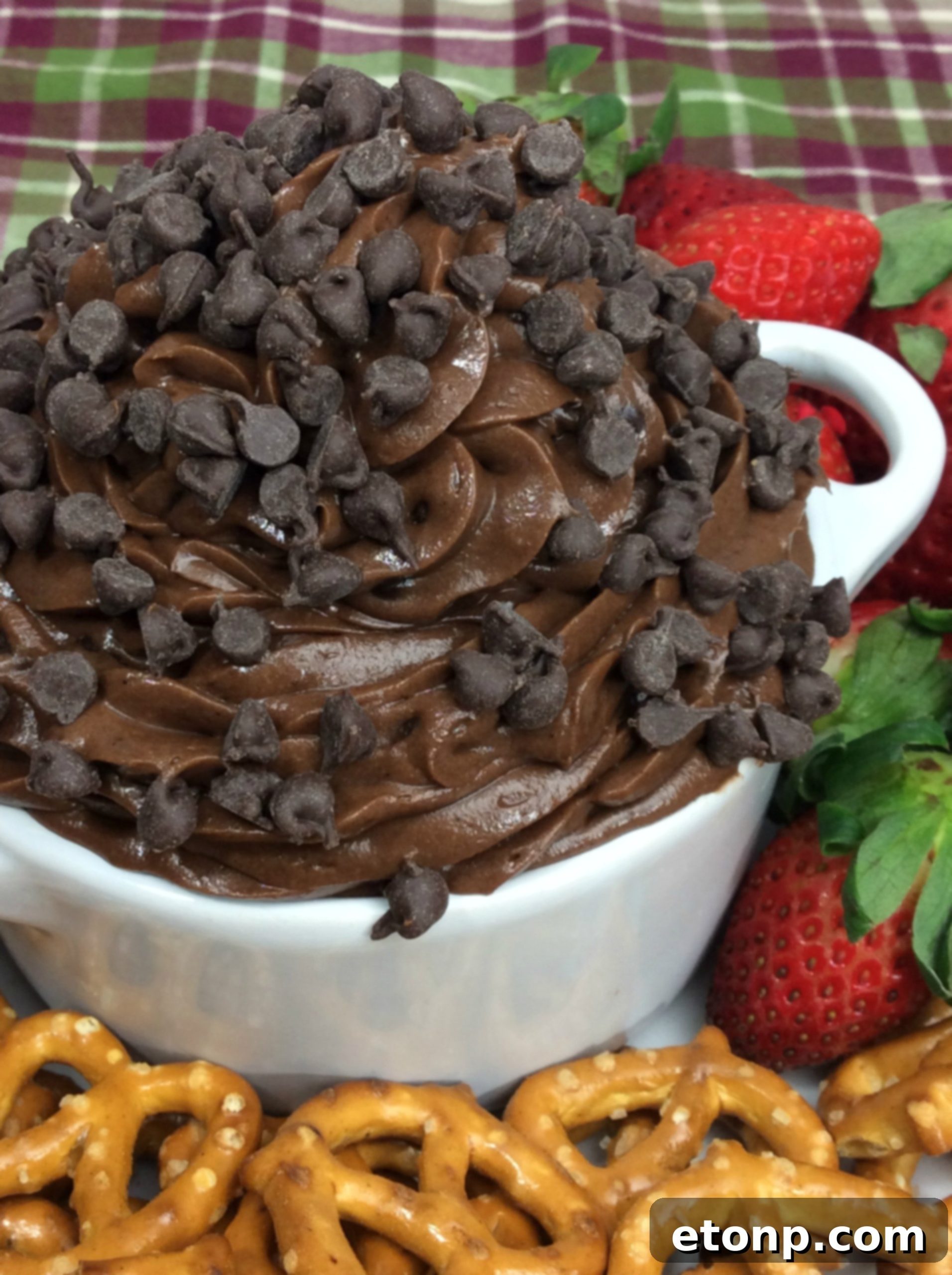 Irresistible Brownie Dip 4 A person enjoying Brownie Batter Dip with a spoon directly from the serving dish, emphasizing its irresistible nature