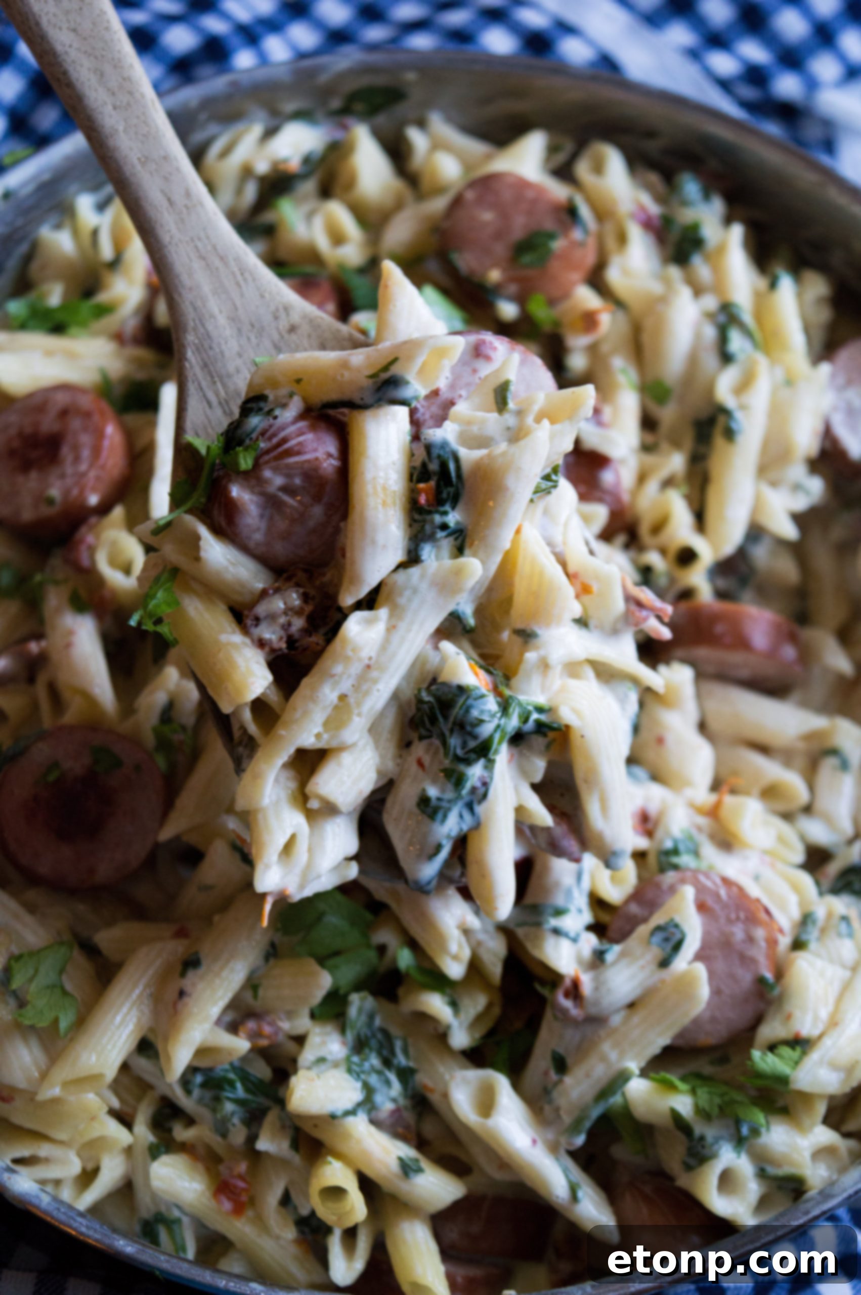 Close-up shot of the creamy pasta sauce bubbling gently in a pan, showcasing the rich texture.