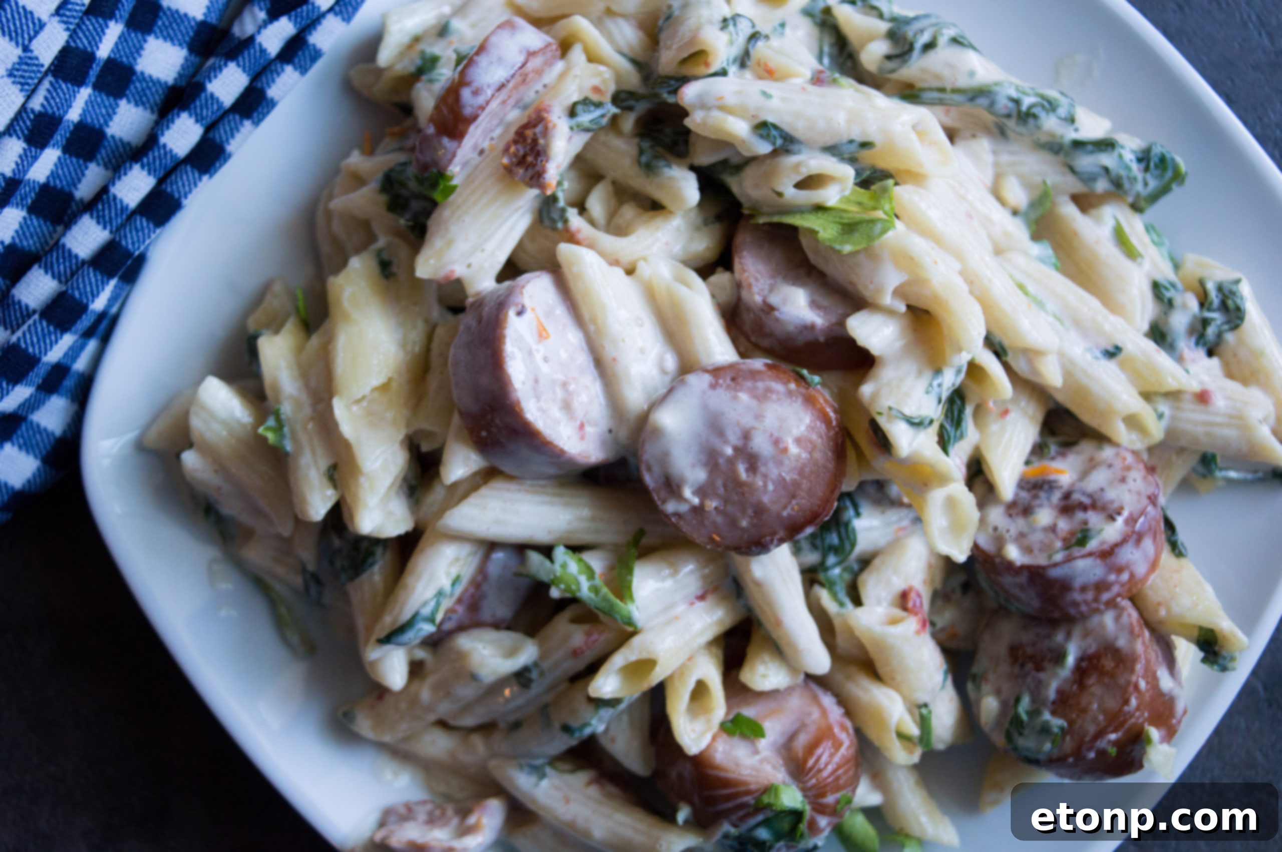 Another close-up of the finished pasta dish, emphasizing the glistening sauce and perfectly cooked ingredients.