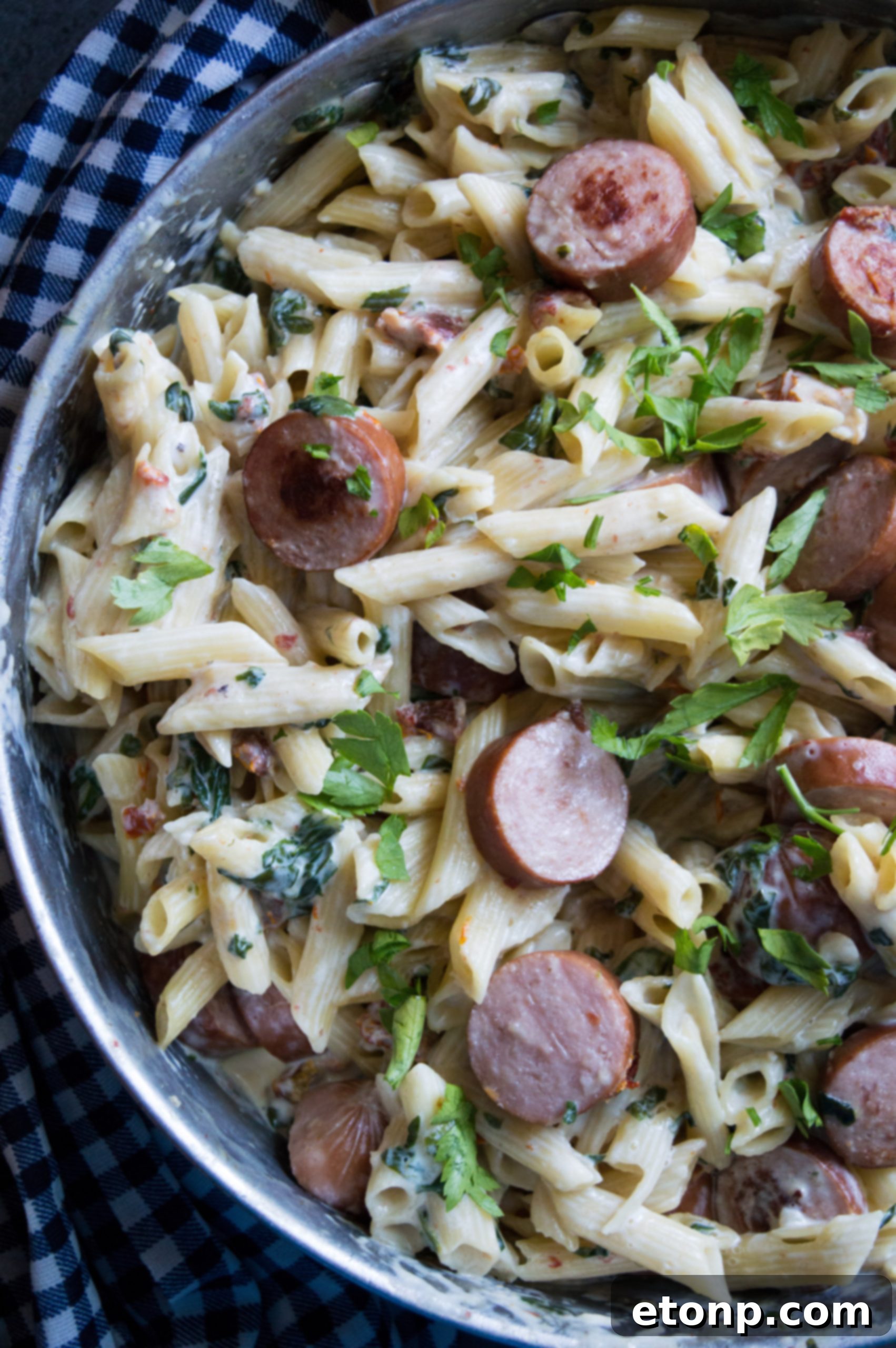 The final cooked dish of creamy pasta presented in a large serving bowl, ready for plating.