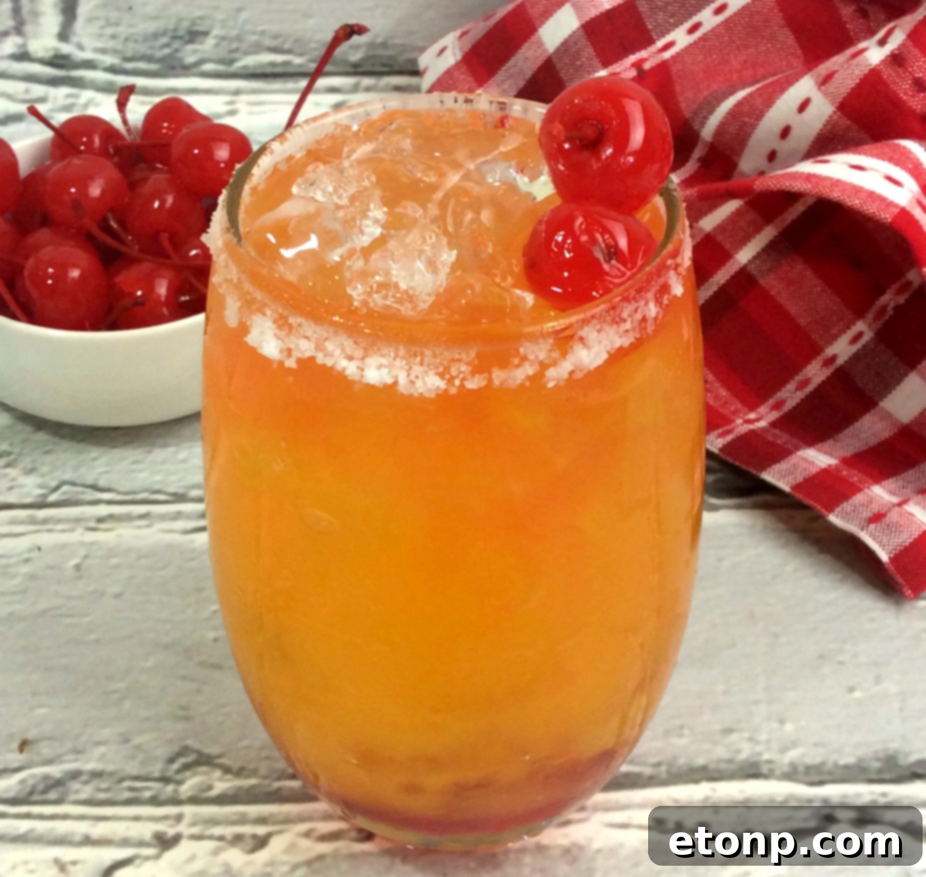 Close-up of the ombre effect in the Take Me on the Couch Cocktail with a cherry garnish, showing the beautiful layers of color.