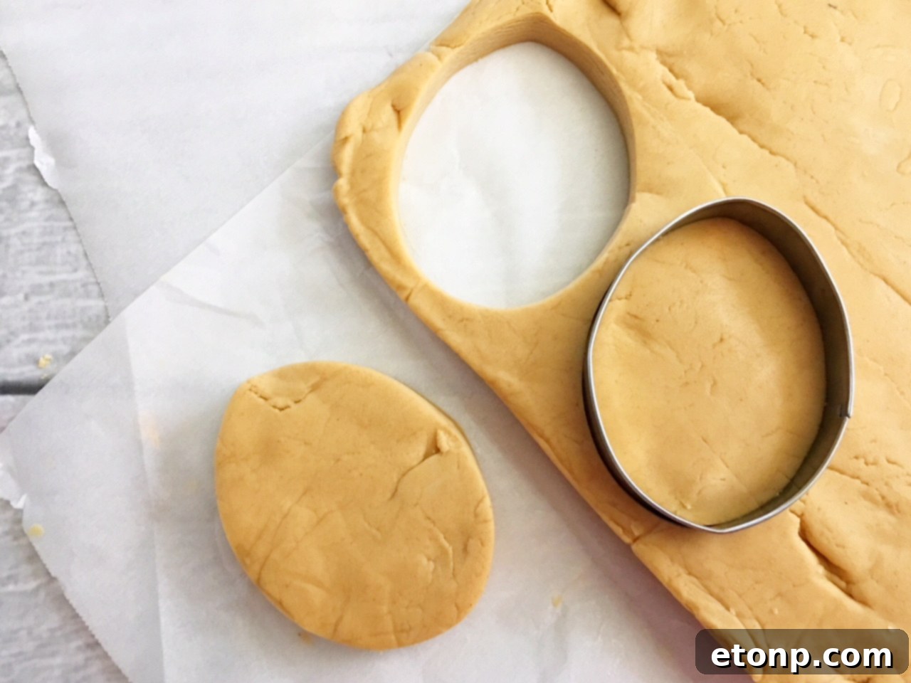 Homemade No-Bake Reese's Peanut Butter Eggs 5 Homemade peanut butter eggs being cut out with an egg-shaped cookie cutter
