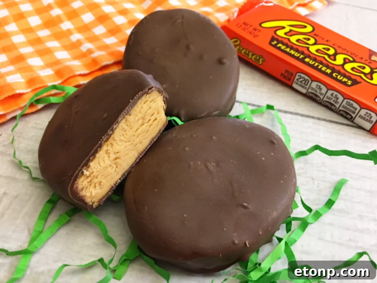 Homemade No-Bake Reese's Peanut Butter Eggs 7 A close-up of a homemade Reese's peanut butter egg cut in half, revealing the creamy peanut butter center