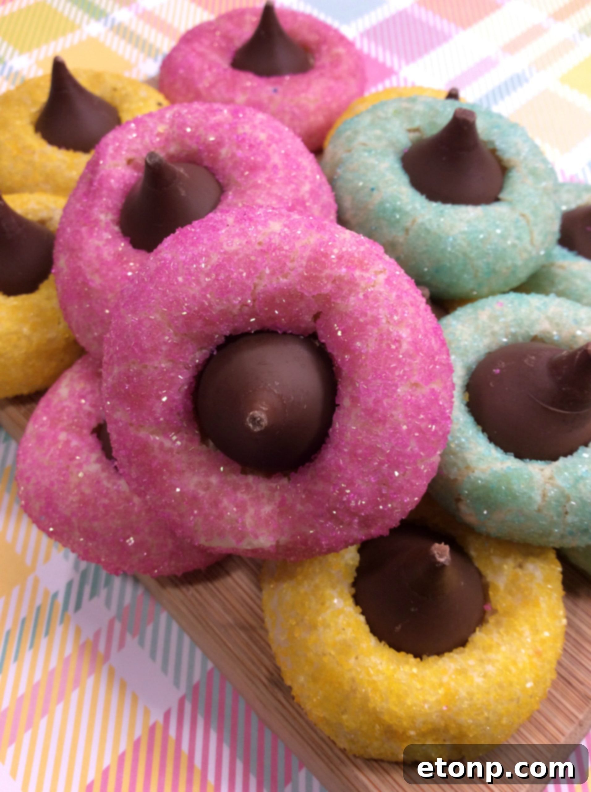 Close-up of freshly baked Springtime Thumbprint Cookies with colorful sprinkles and Hershey's Kisses