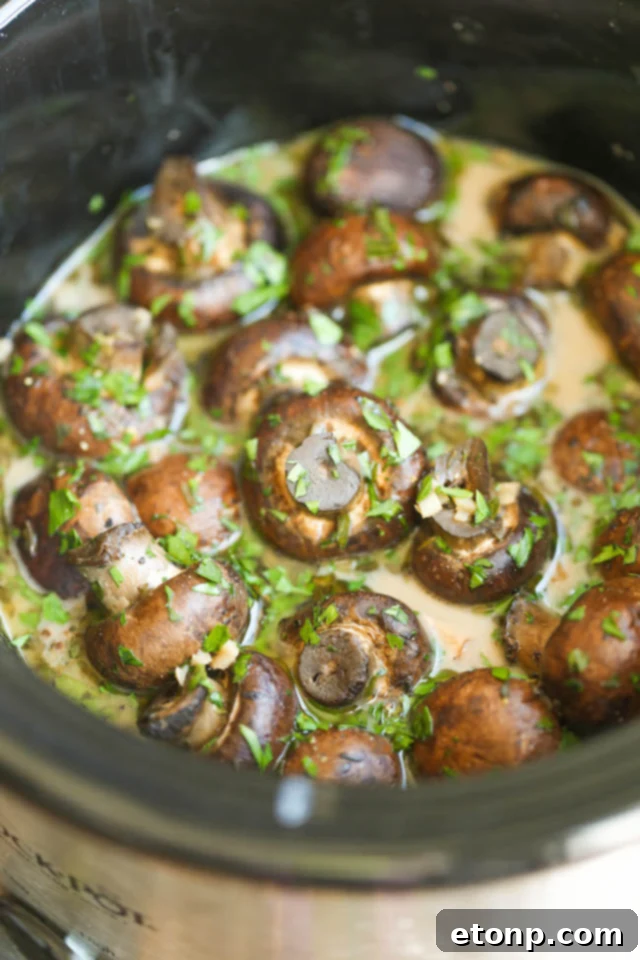 Savory Slow Cooker Garlic-Herb Mushrooms in a white serving bowl