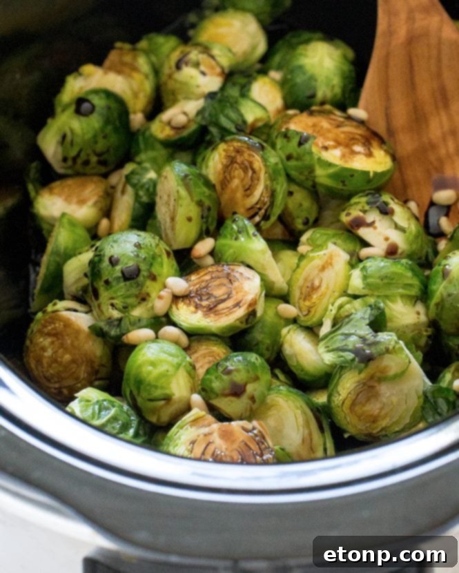 Caramelized Slow Cooker Balsamic Brussels Sprouts glistening in a serving dish