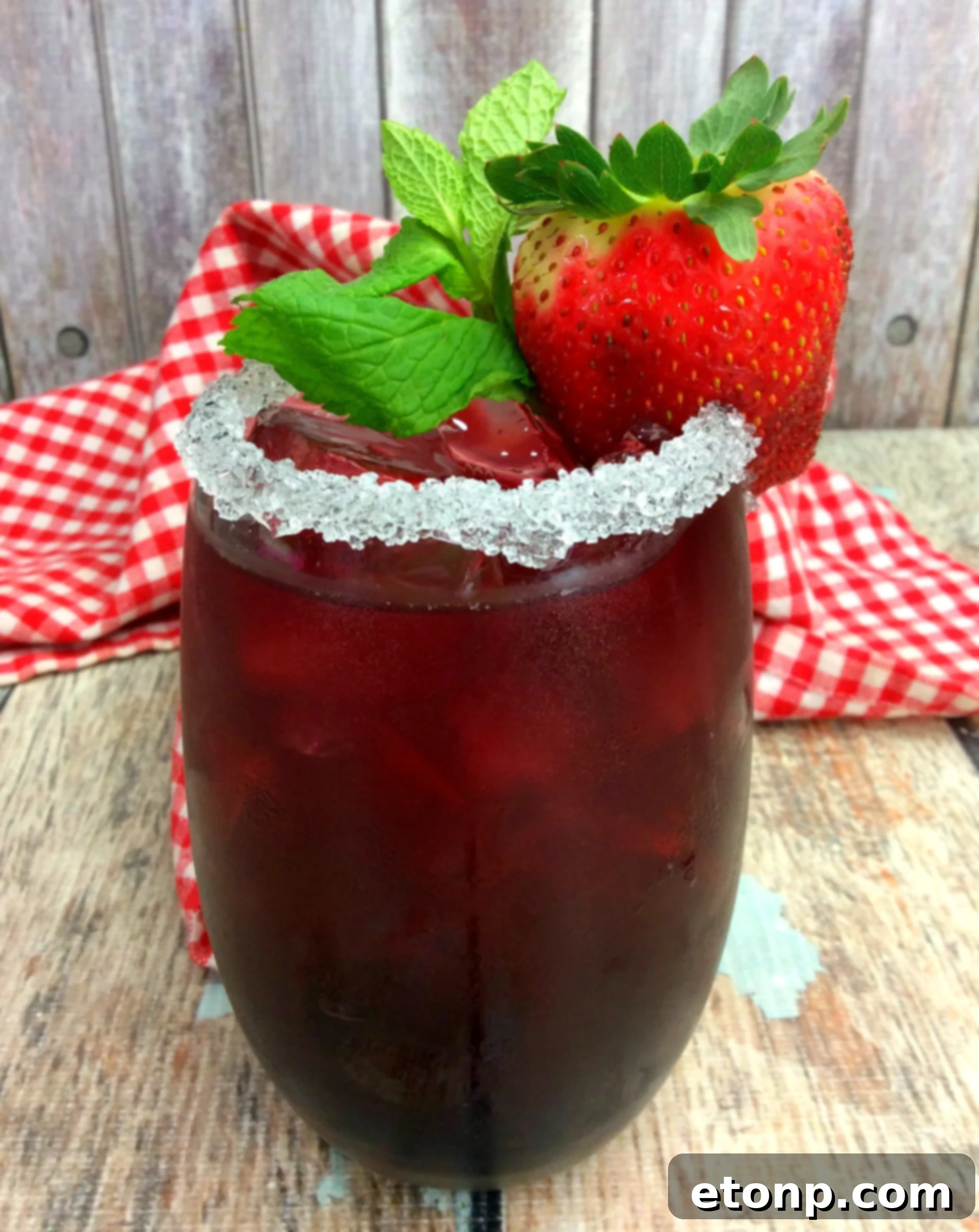 Refreshing Tickle Me Strawberry Triple Crown Cocktail with fresh strawberries and mint