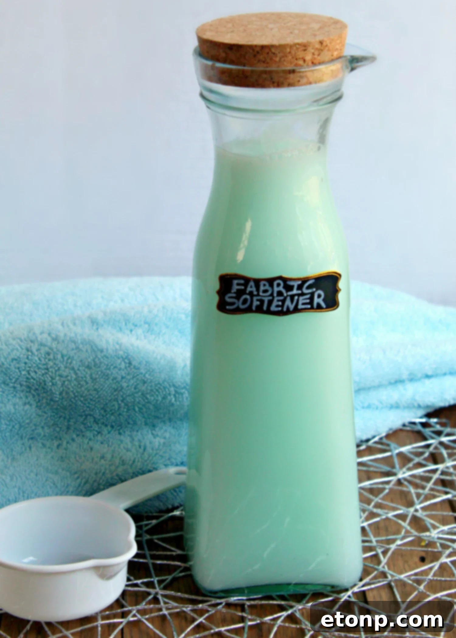 Homemade Fabric Softener Ingredients displayed on a wooden surface.