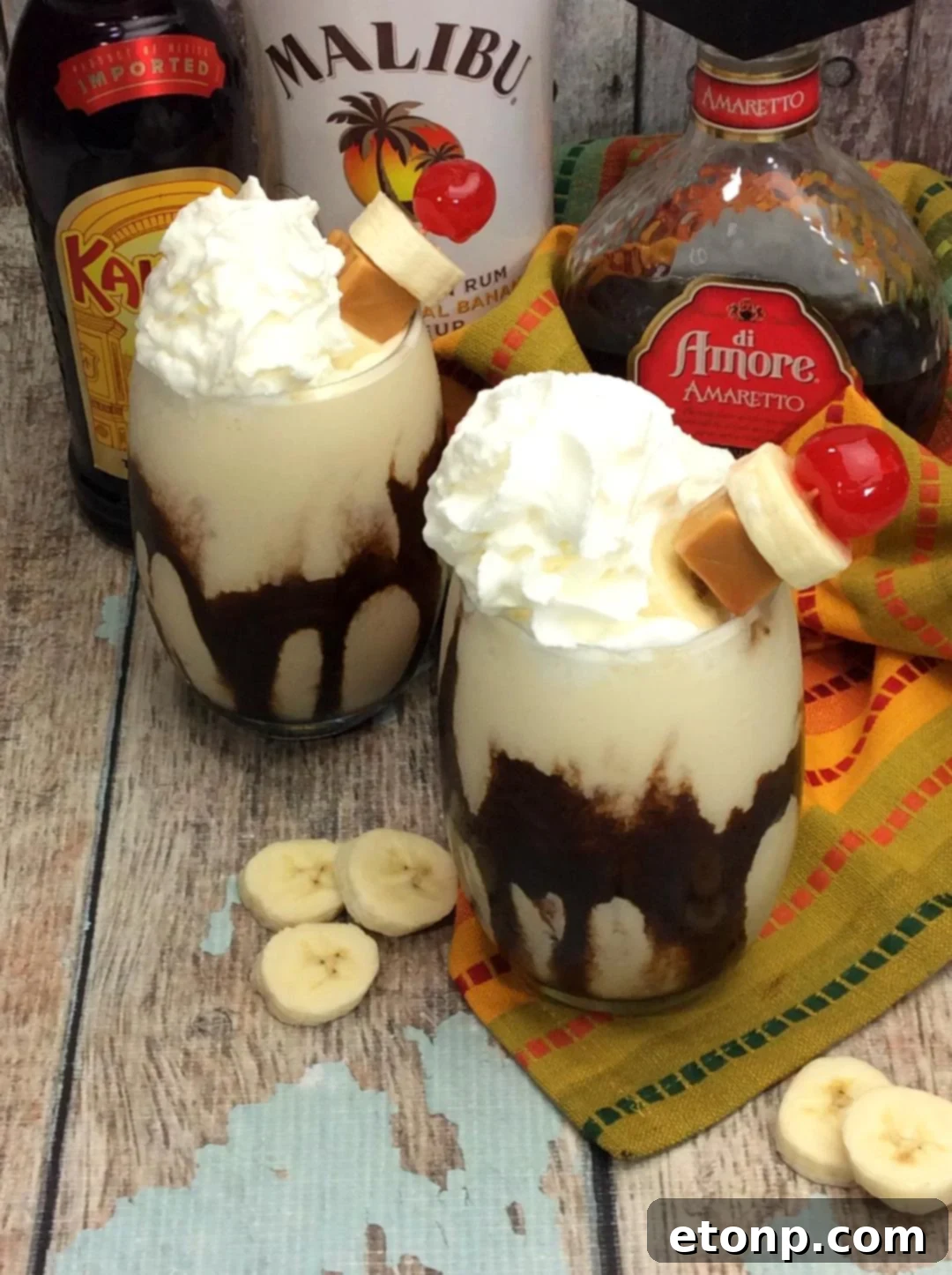 Chunky Monkey Cocktail with a generous dollop of whipped cream, chocolate syrup, and a maraschino cherry on top