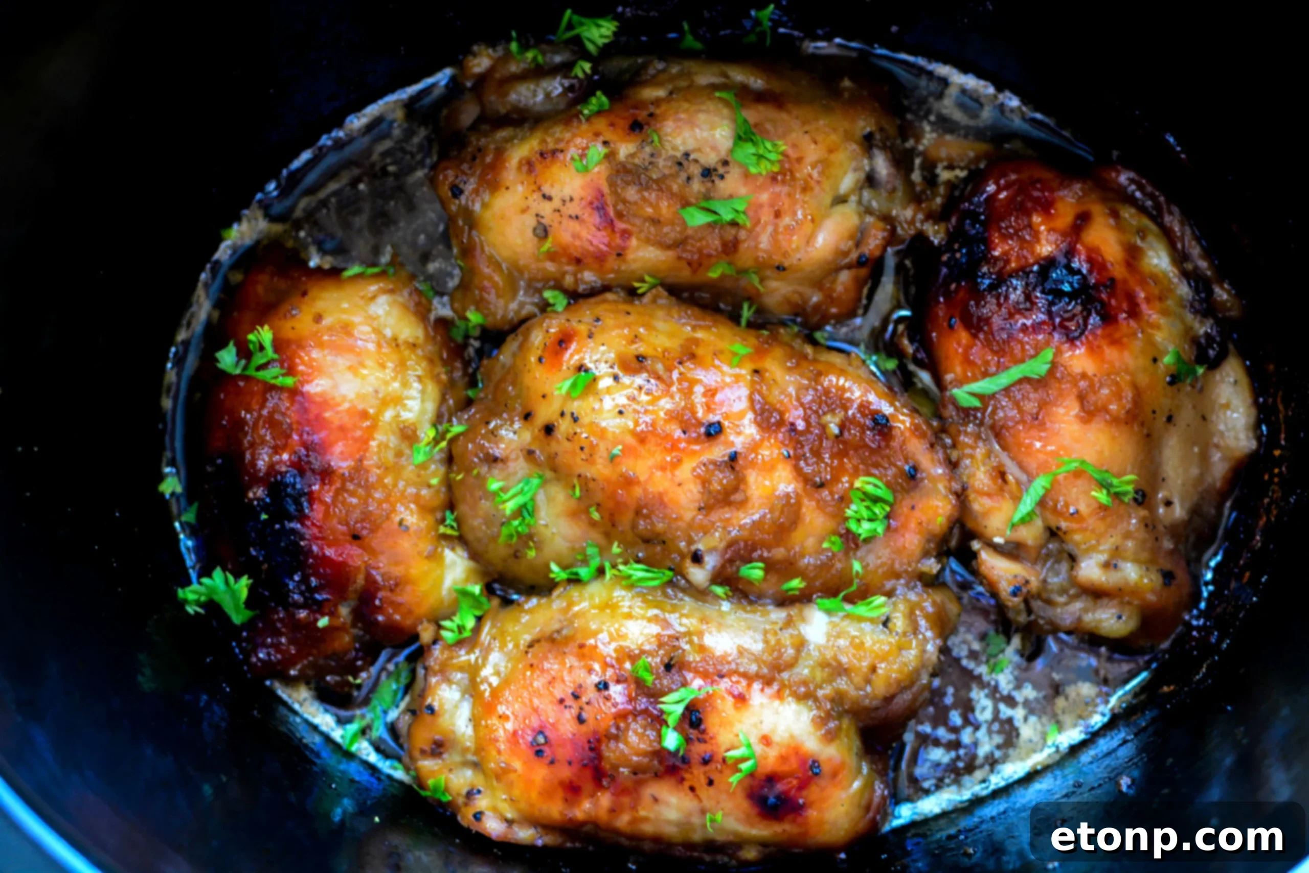 Tender Crock Pot Garlic Brown Sugar Chicken served with fluffy white rice, garnished with fresh herbs.