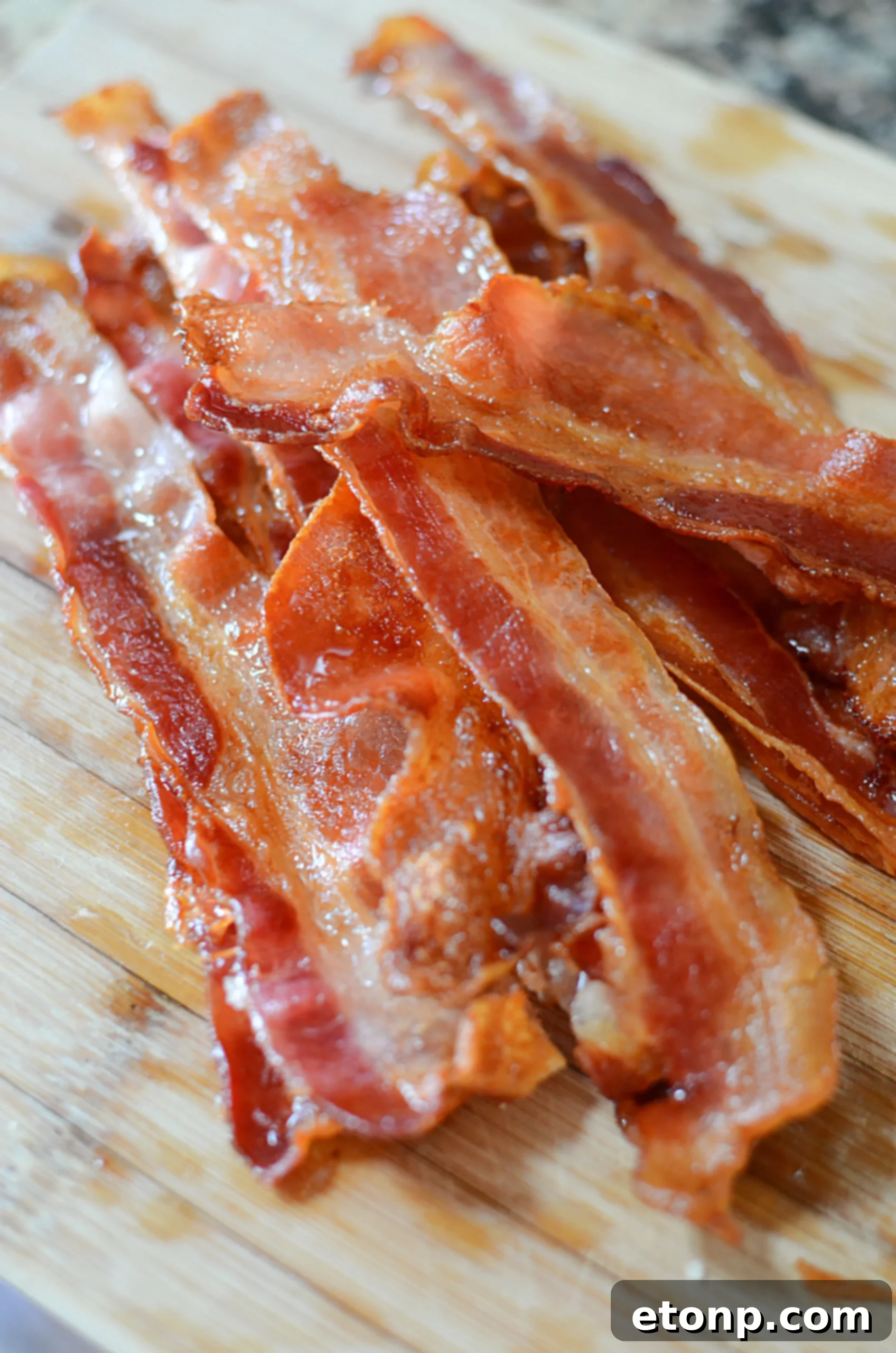 Perfectly cooked bacon slices arranged on a baking sheet, ready to be served