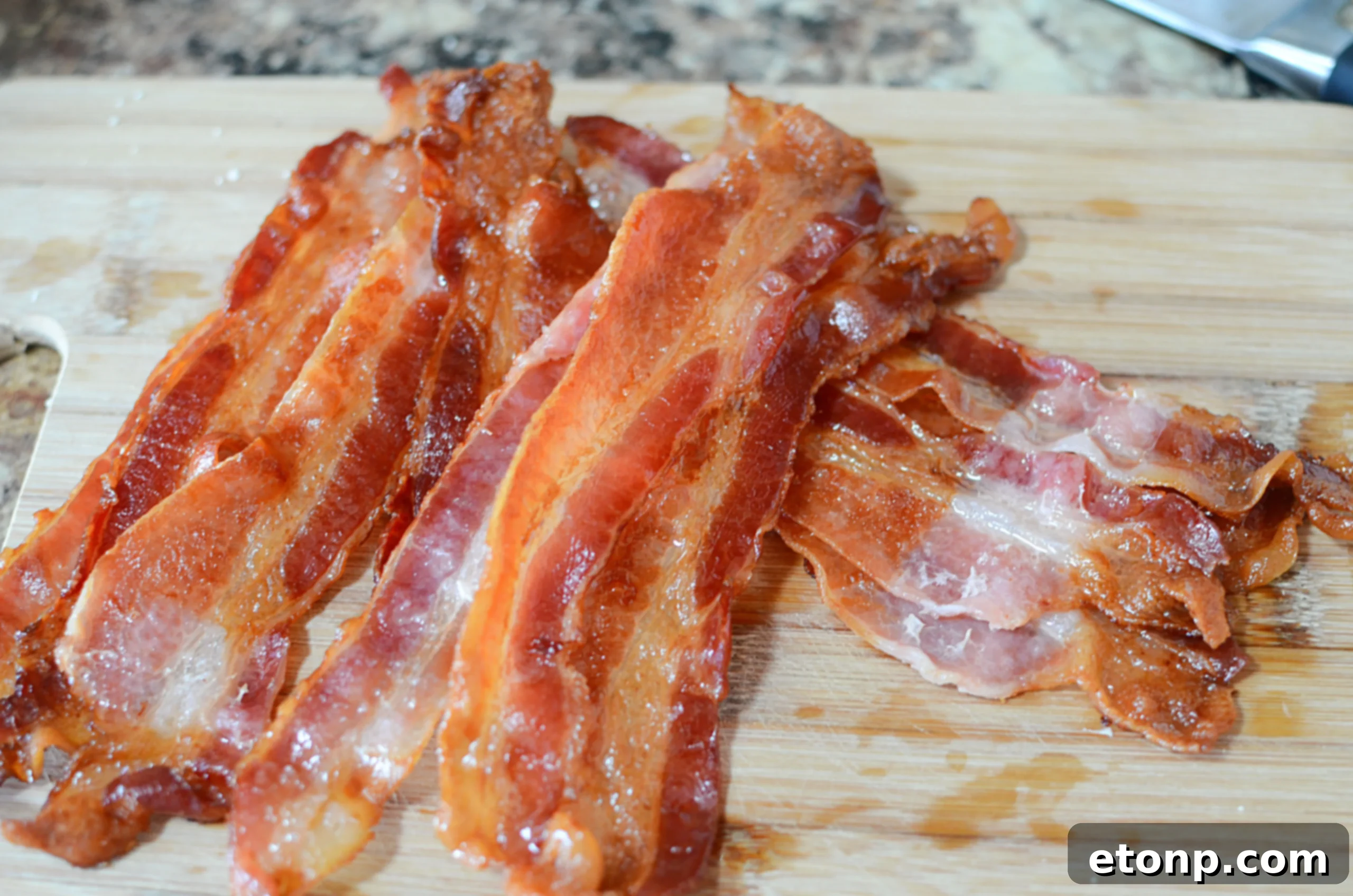 A plate piled high with delicious, crispy oven-baked bacon, ready to be enjoyed