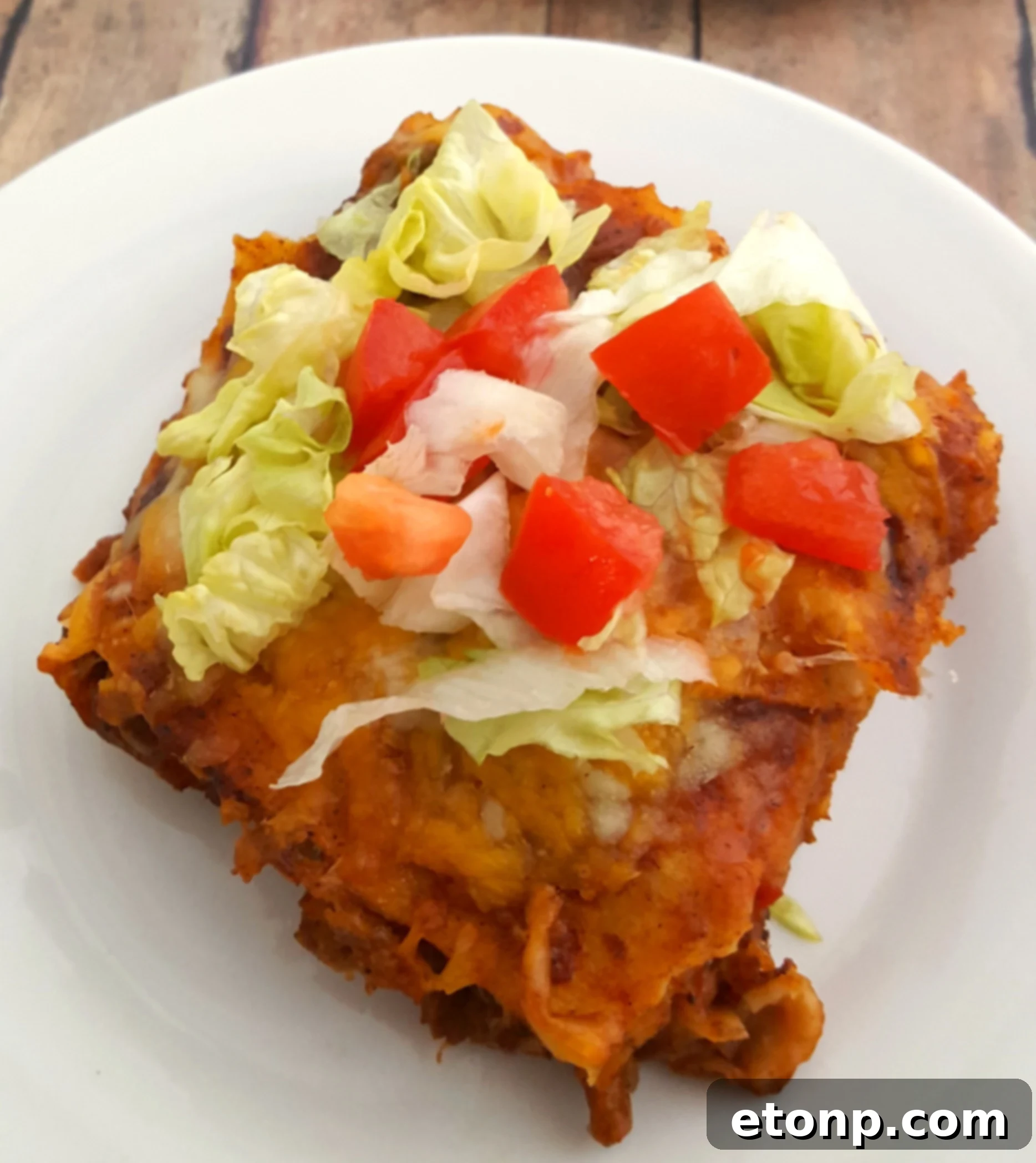 Delicious slice of Mexican Lasagna with melted cheese and fresh toppings