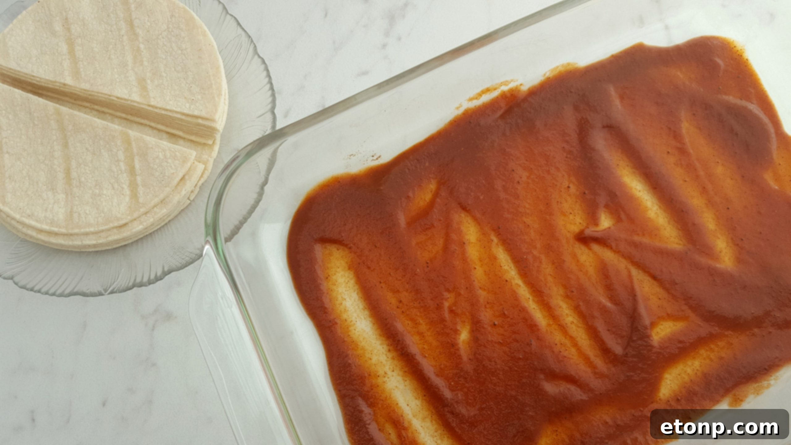 Preparing the layers of Mexican Lasagna in a baking dish