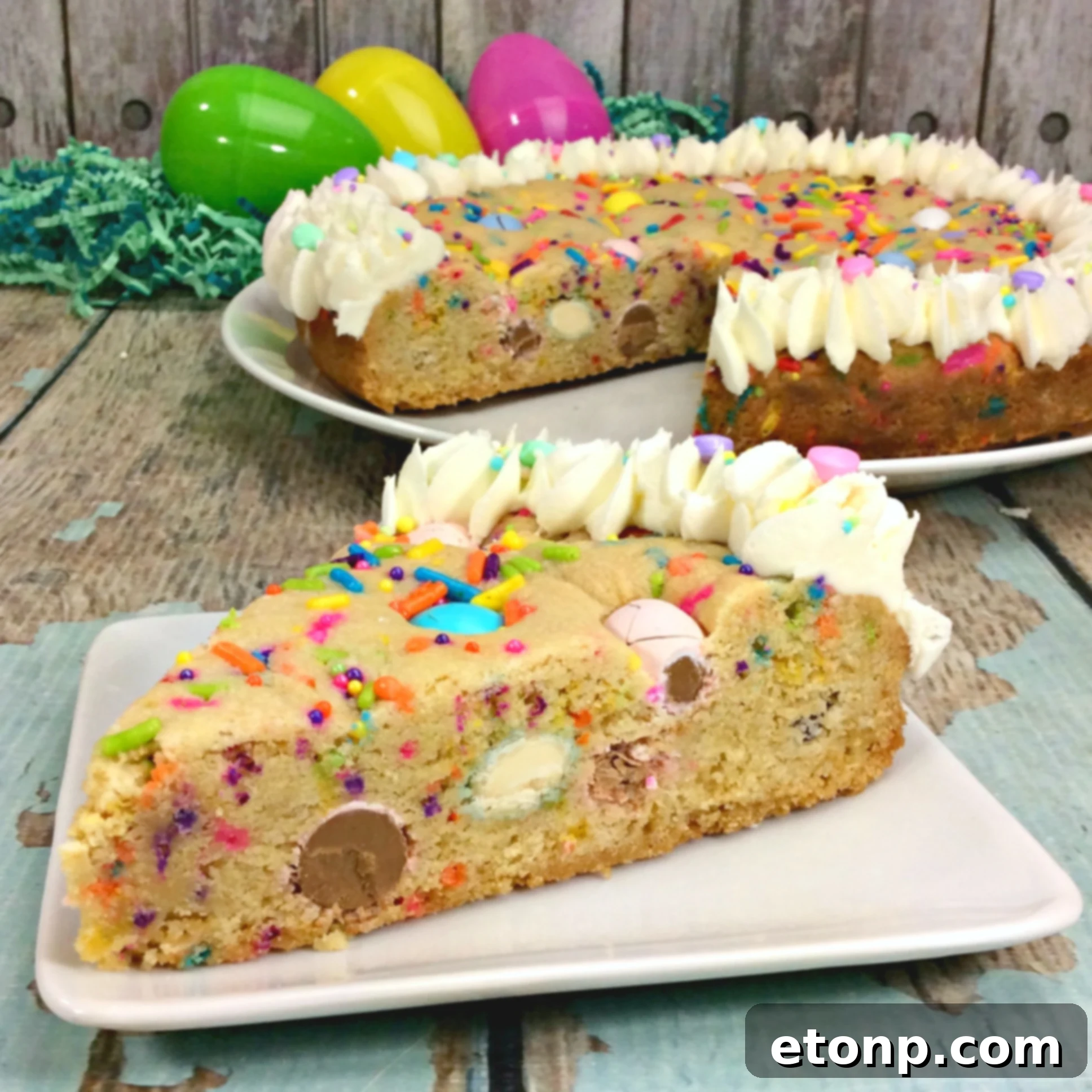 Vibrant Easter Cookie Pie, adorned with pastel M&Ms and sprinkles, presented on a decorative plate, ready to be enjoyed.